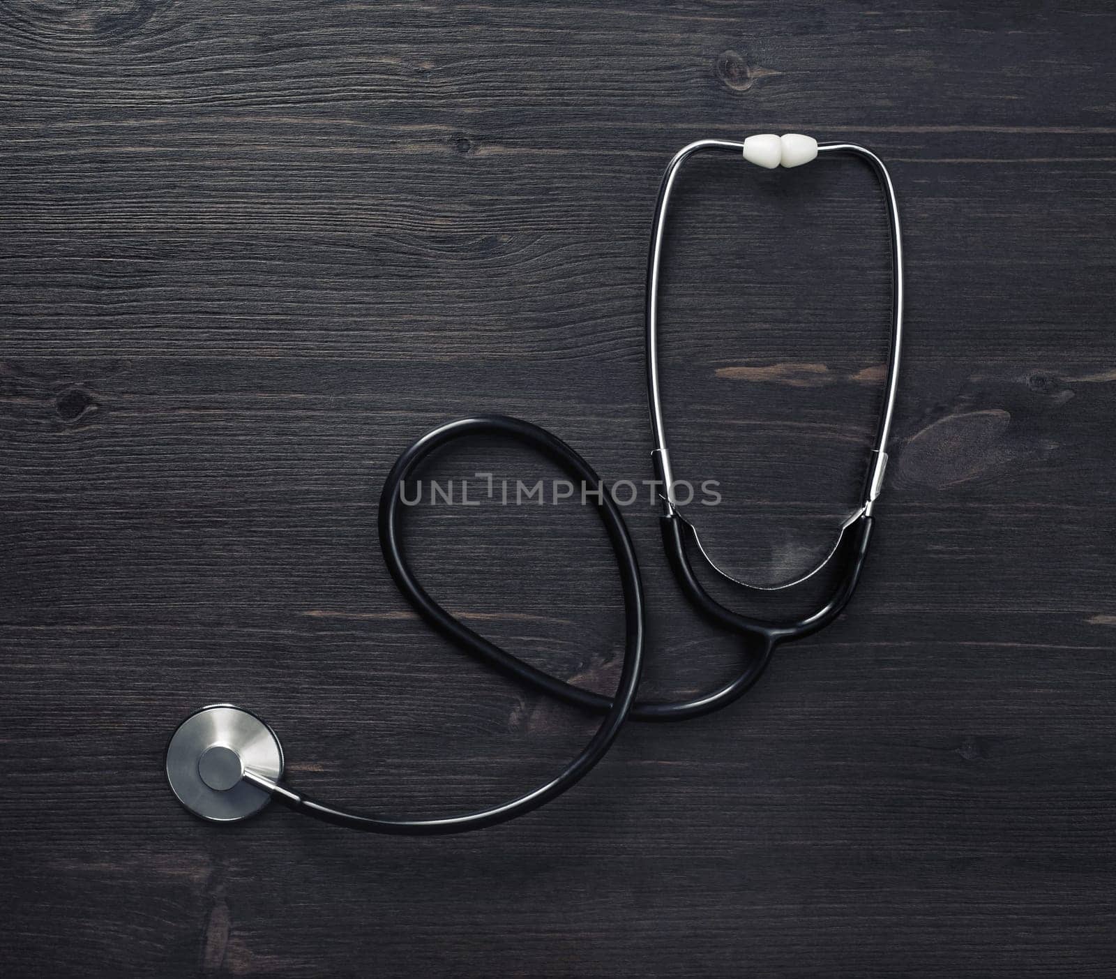 Stethoscope on wood table background. Top view. Flat lay.