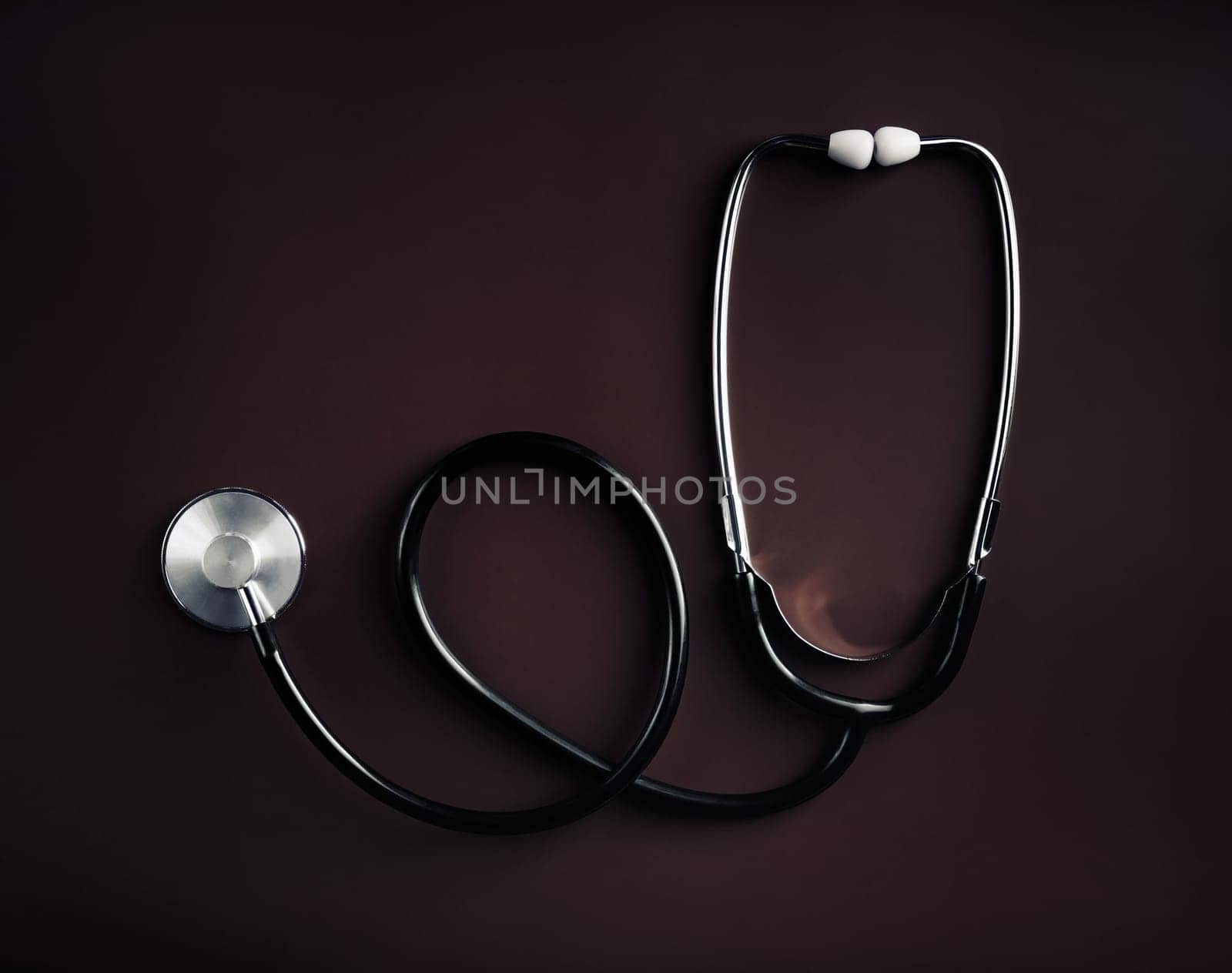 Medical stethoscope on dark background. Top view. Flat lay.