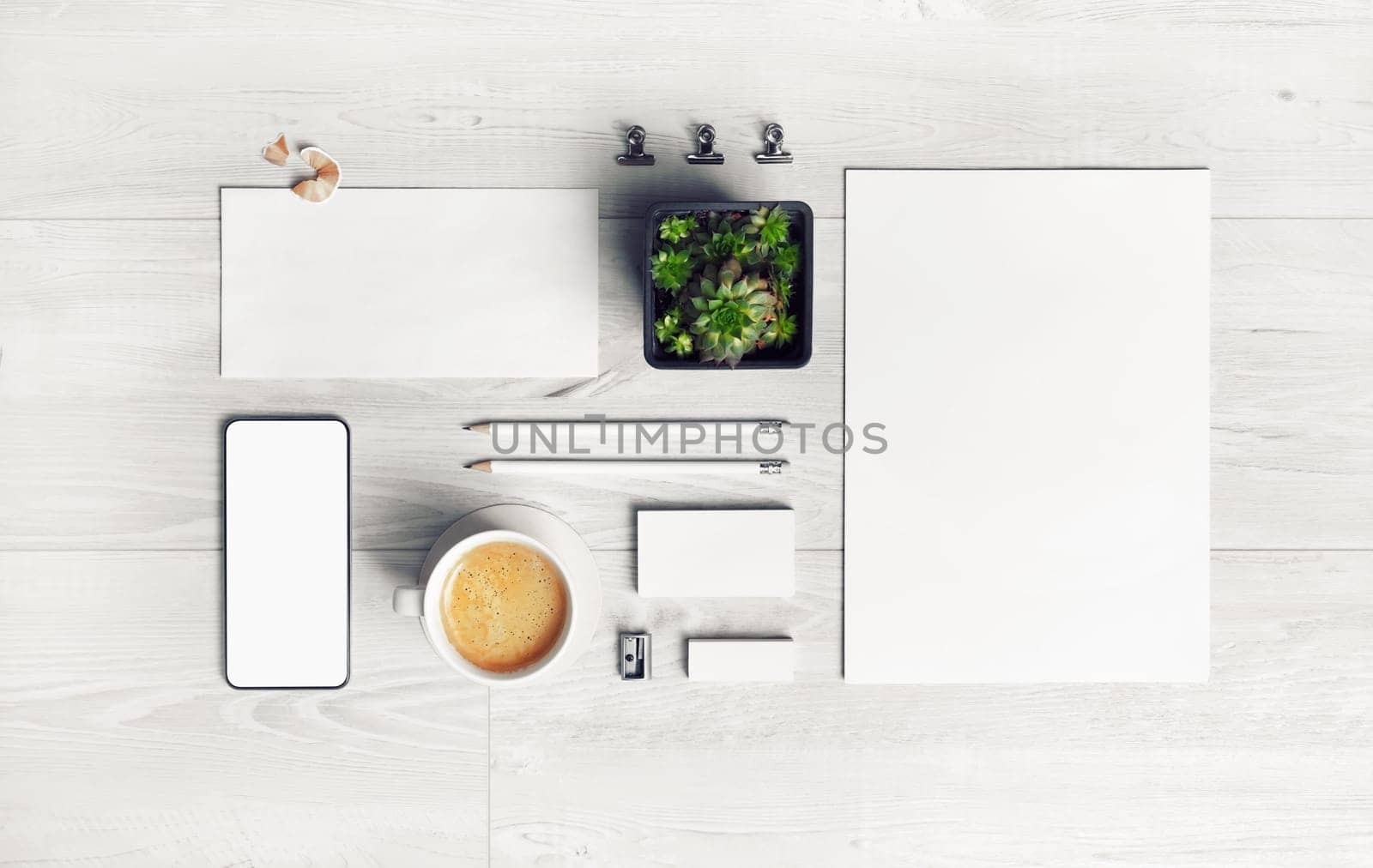 Blank stationery set on light wooden background. For graphic designers presentations and portfolios. Top view. Flat lay.