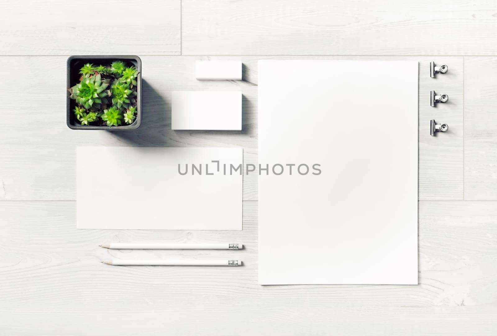 Blank corporate stationery set on light wooden background. Template for branding design. Branding mock up. Top view. Flat lay.
