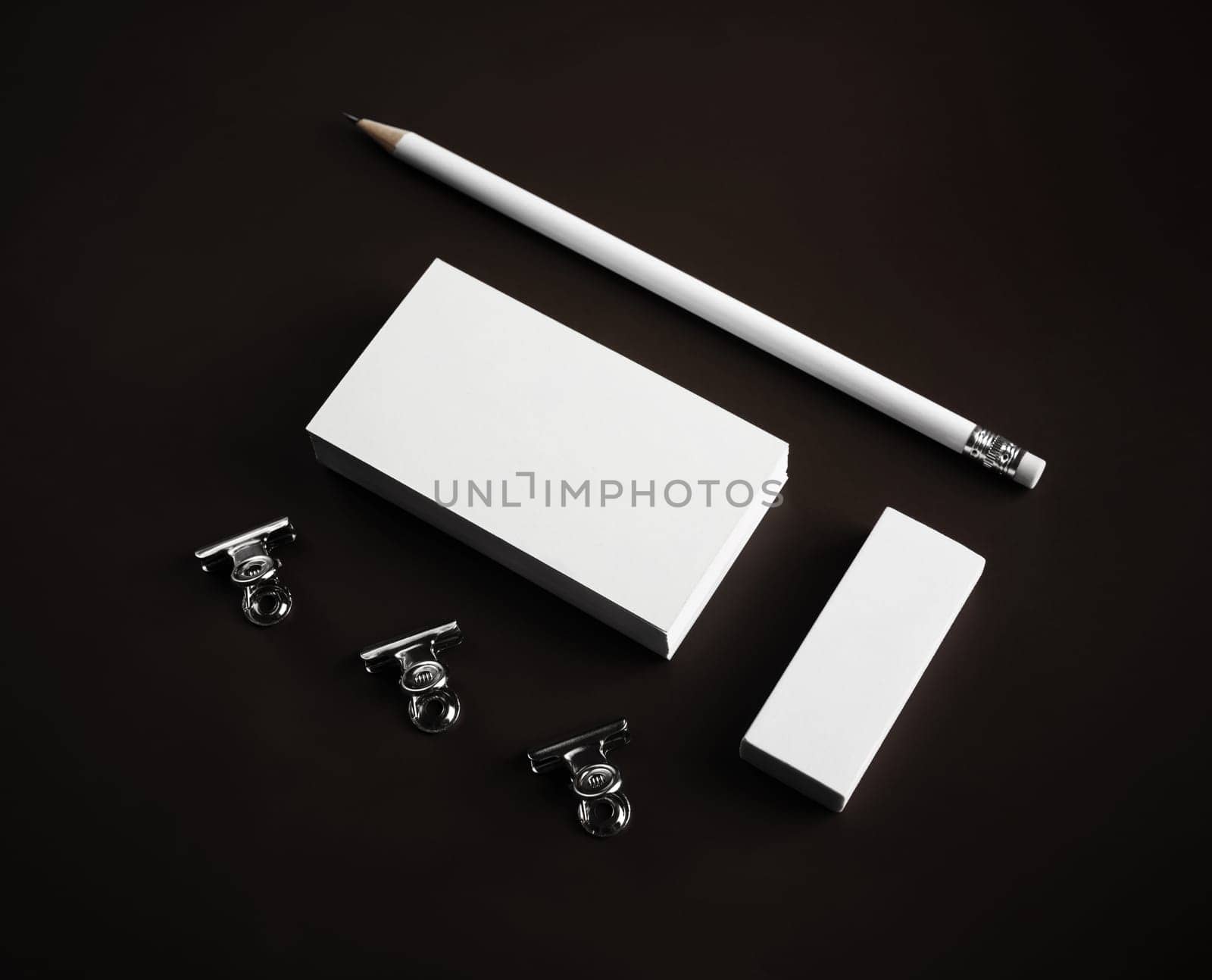 Photo of blank business cards, pencil, eraser and clips. Mockup for ID.