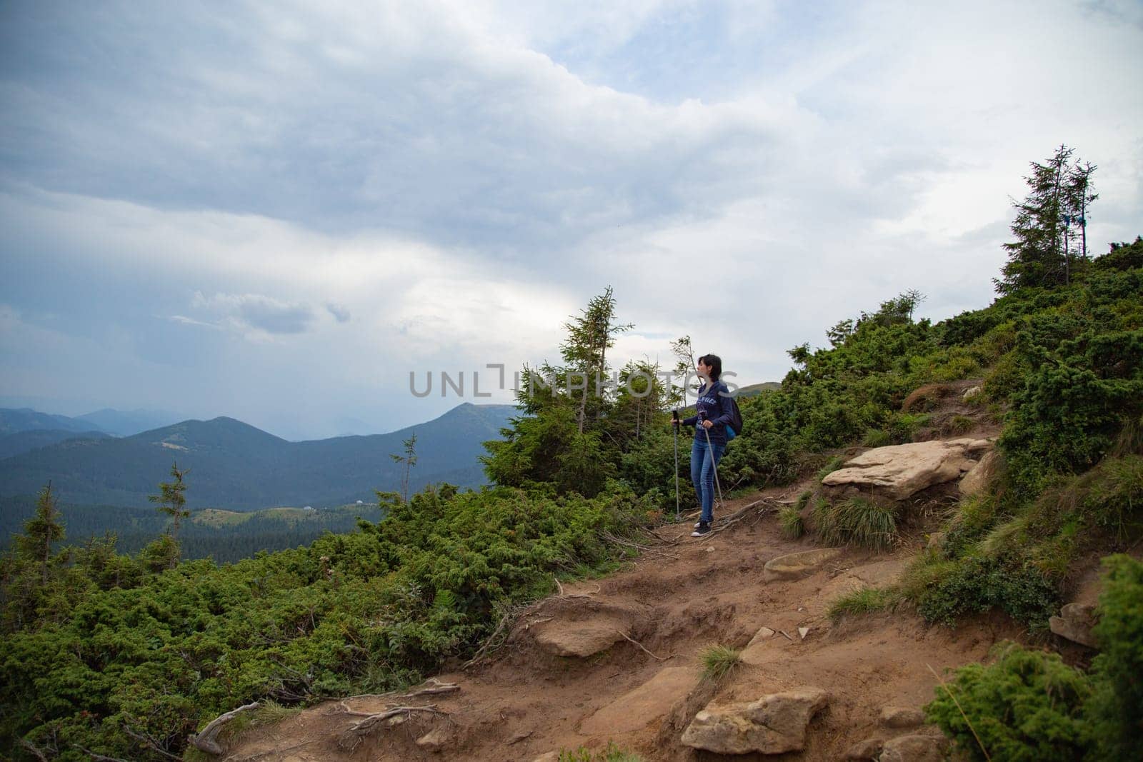 Girl Descend Down a Large Green Mountain Range.