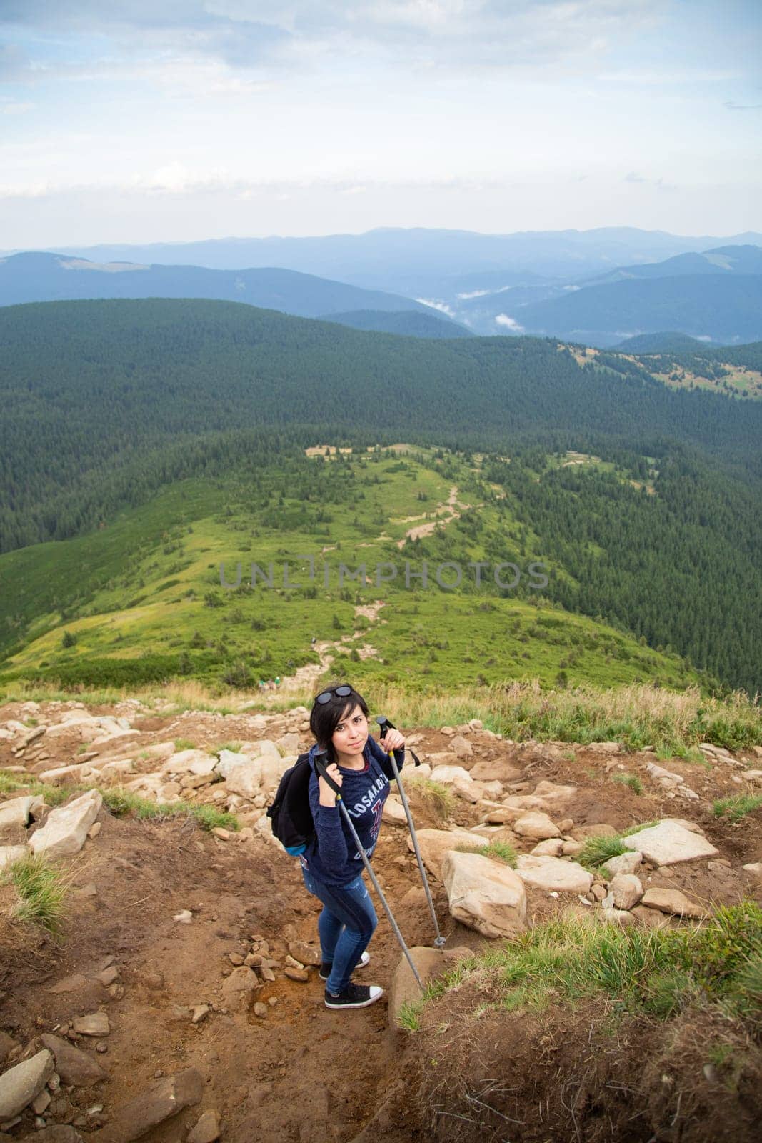 Girl Descend Down a Large Green Mountain Range.