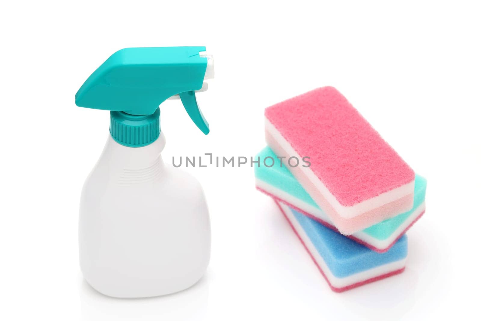 Spray plastic bottle and cleaning sponge on a white background
