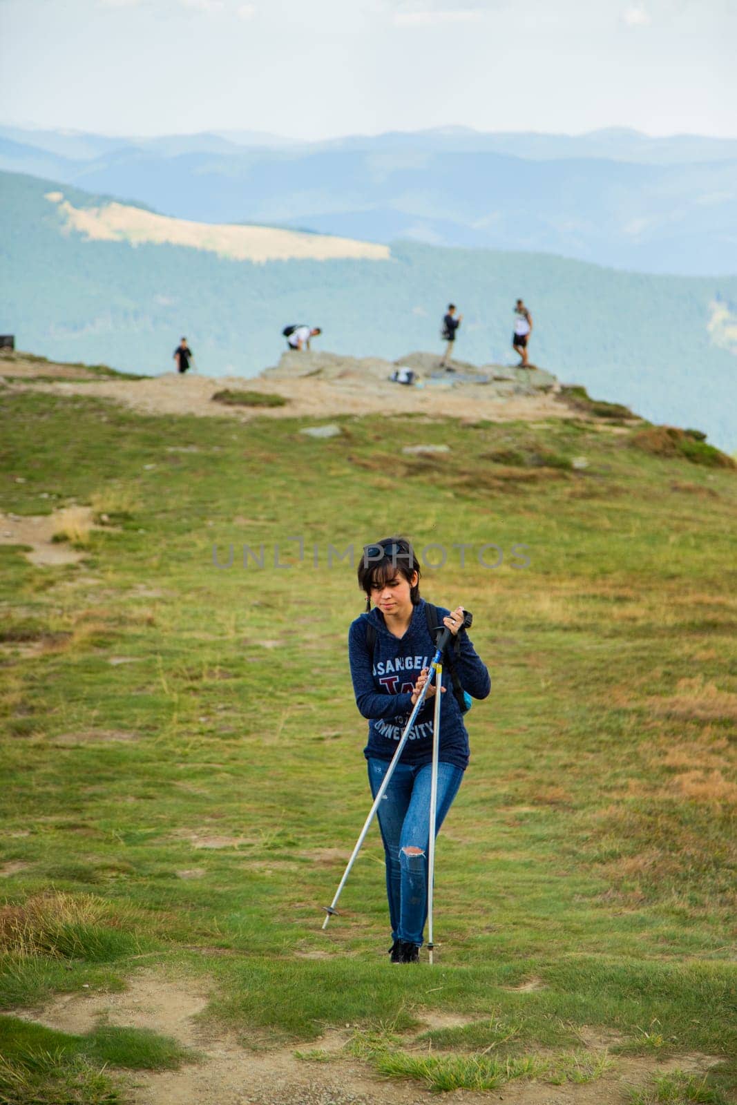Girl Descend Down a Large Green Mountain Range.