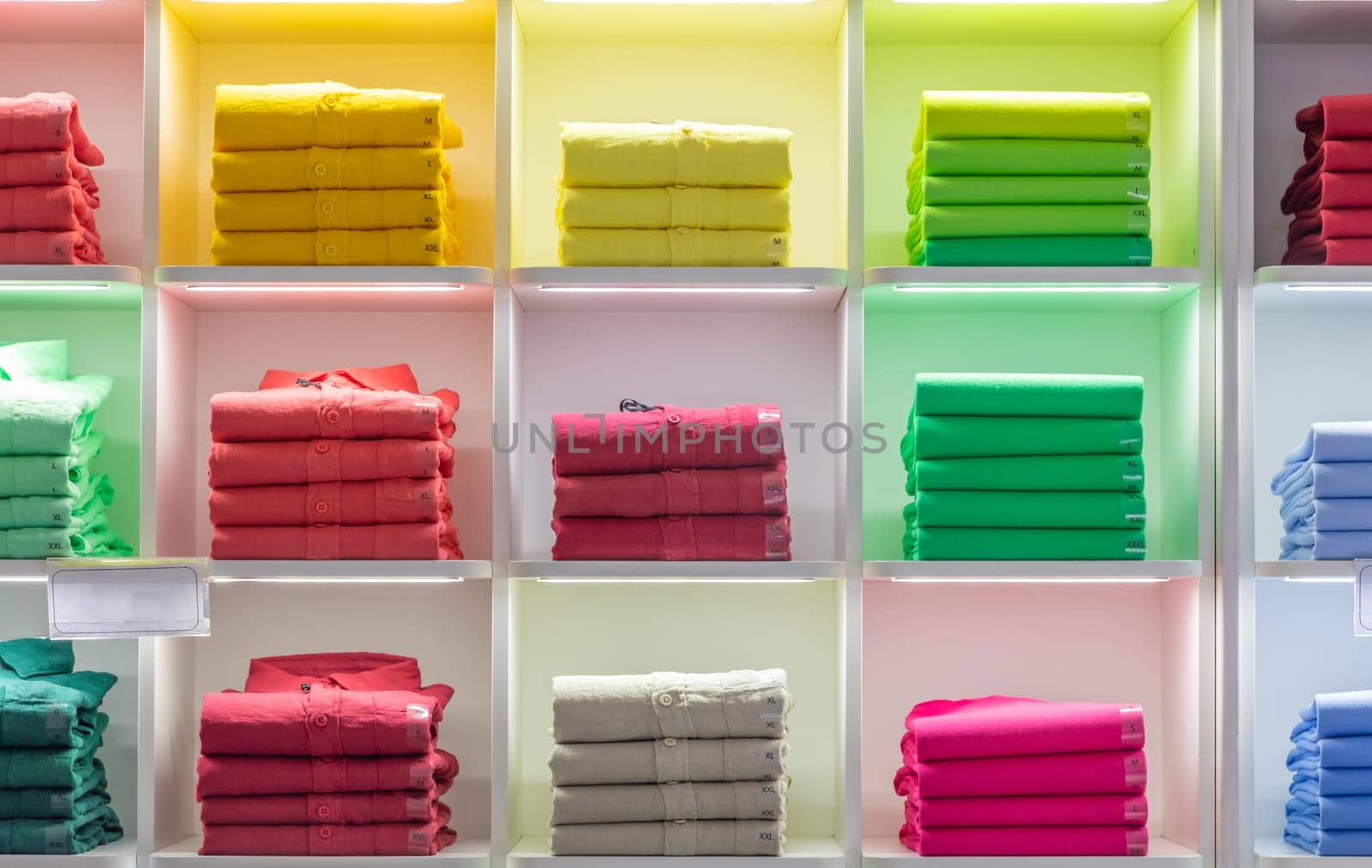 Polo t-shirt store interior. Shop shelves with  colored fashion cotton shirts.
