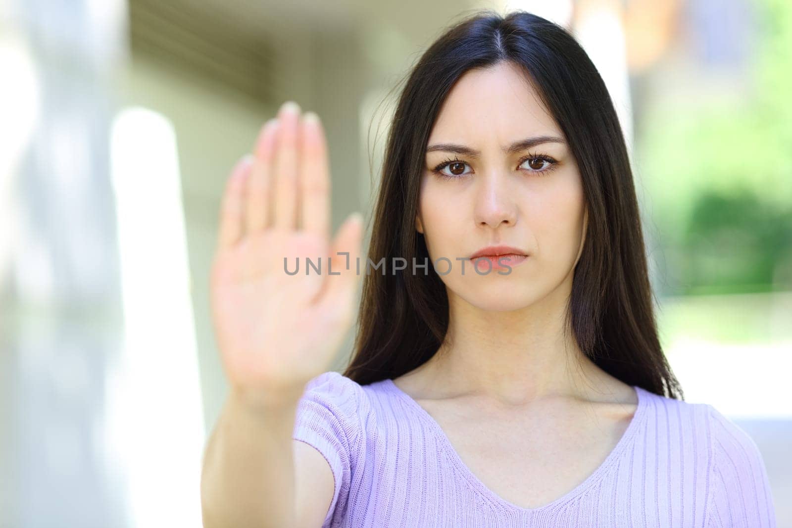 Asian woman gesturing stop in the street