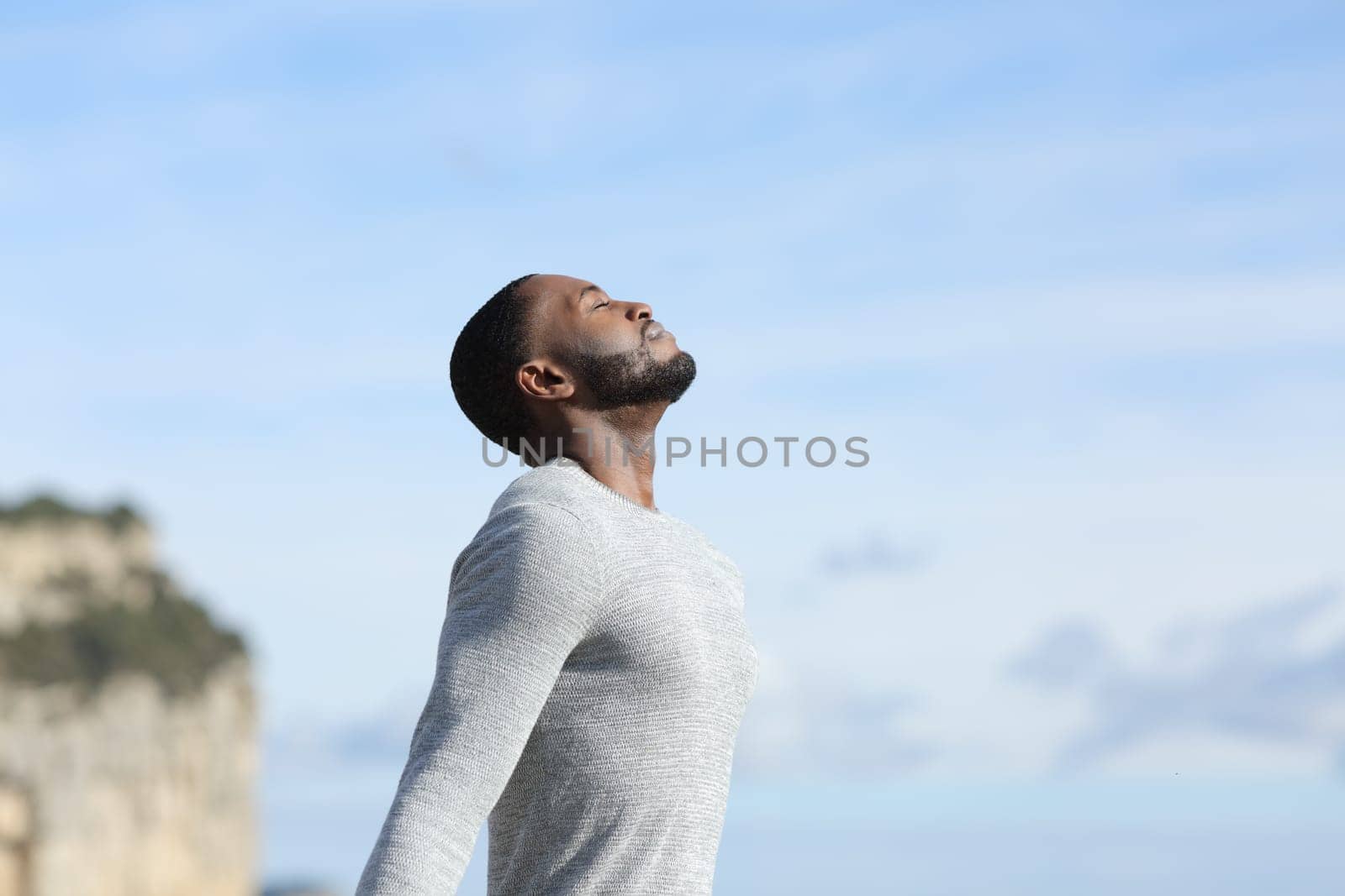 Man with black skin relaxing breathing fresh air outside
