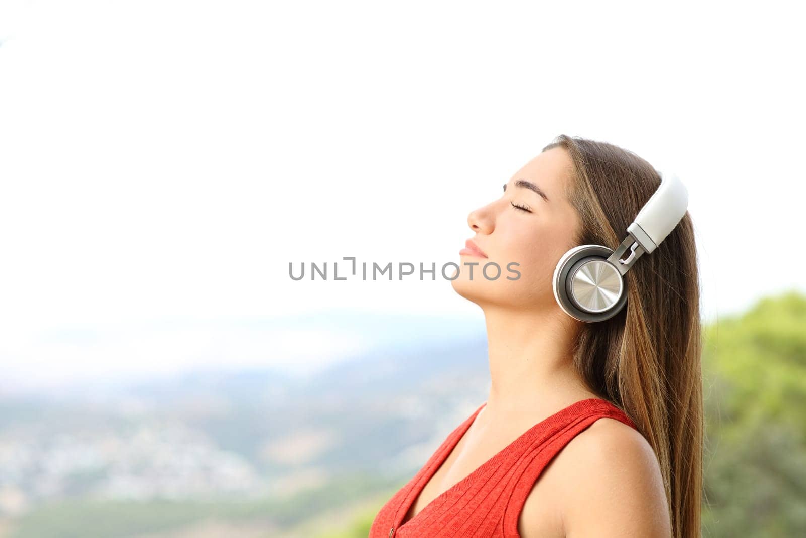 Teenager breathing fresh air wearing wireless headphones