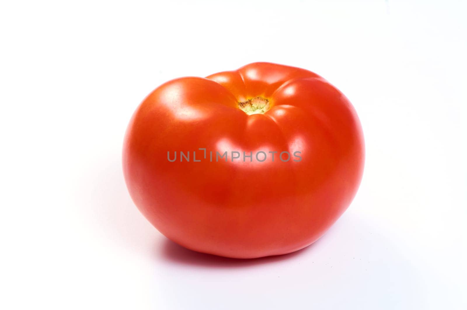 Juicy red tomato on a white isolated background. High quality photo