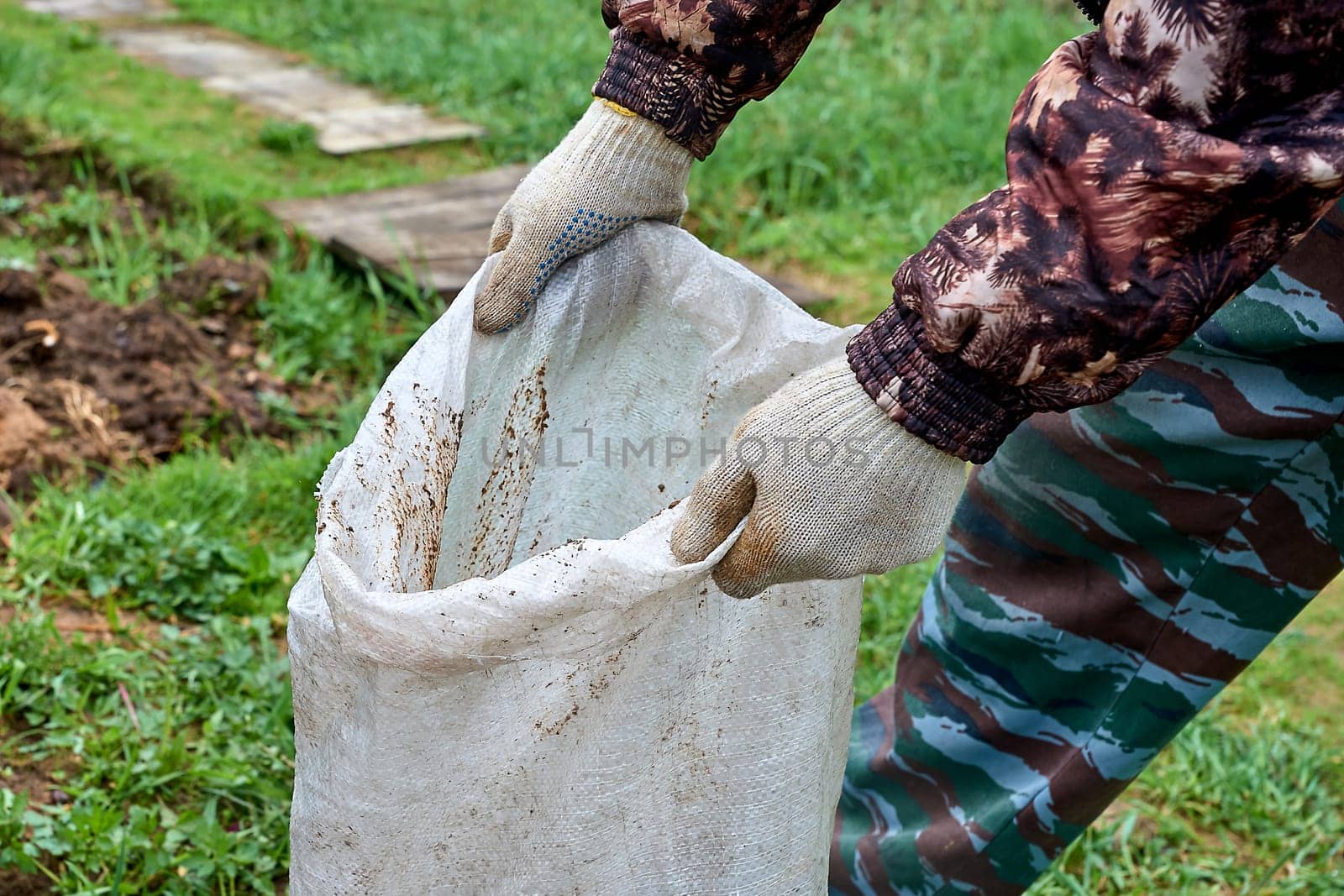 hands holding an open potato bag. High quality photo