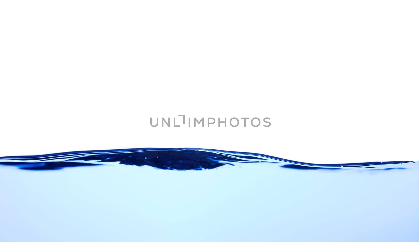 Light blue water wave with air bubbles and a little bit splashed underwater, studio shot isolated on white background. The abstract clean surface on liquid