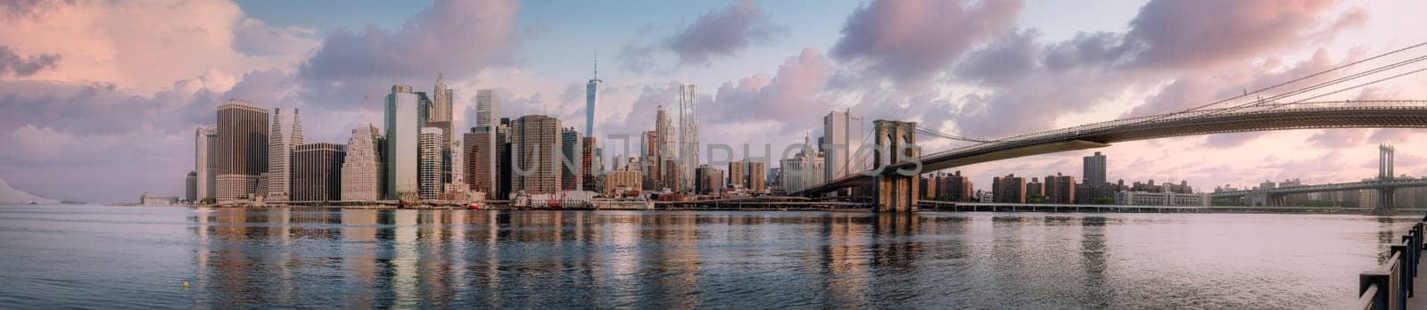 Panoramic view of New York City skyline with urban skyscrapers at sunset, USA.