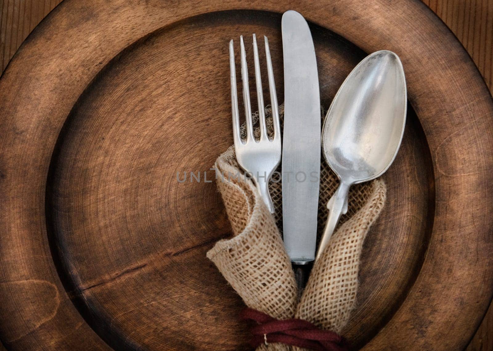 Vintage silverware on rustick wooden plate