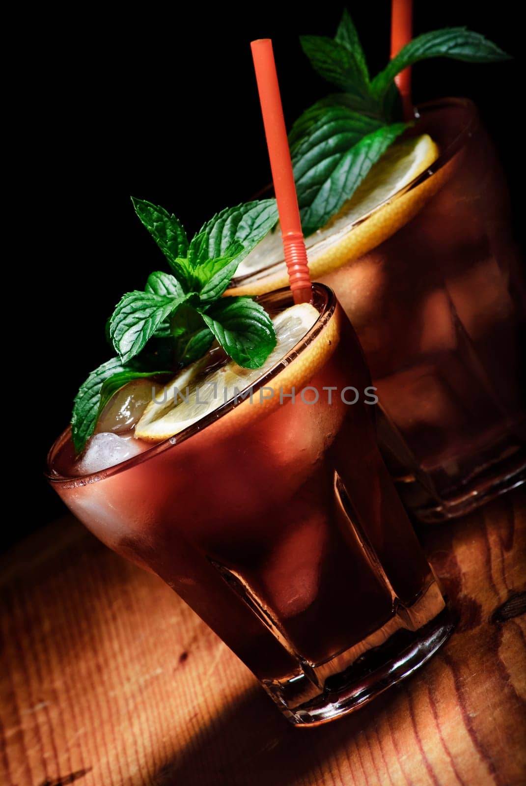 Cuba Libre cocktail on rustic wooden background