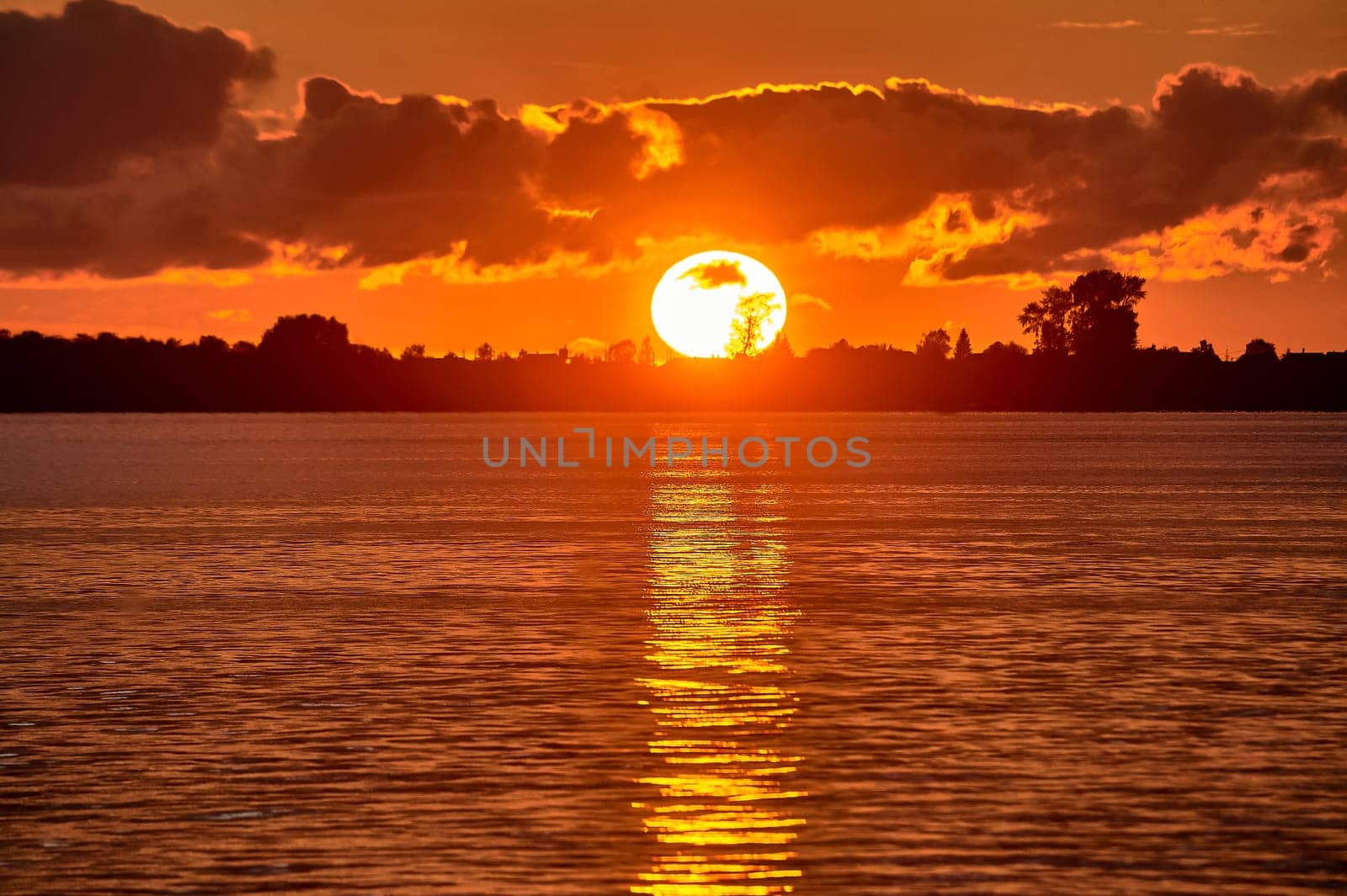 Sunset on the river, big sun. High quality photo