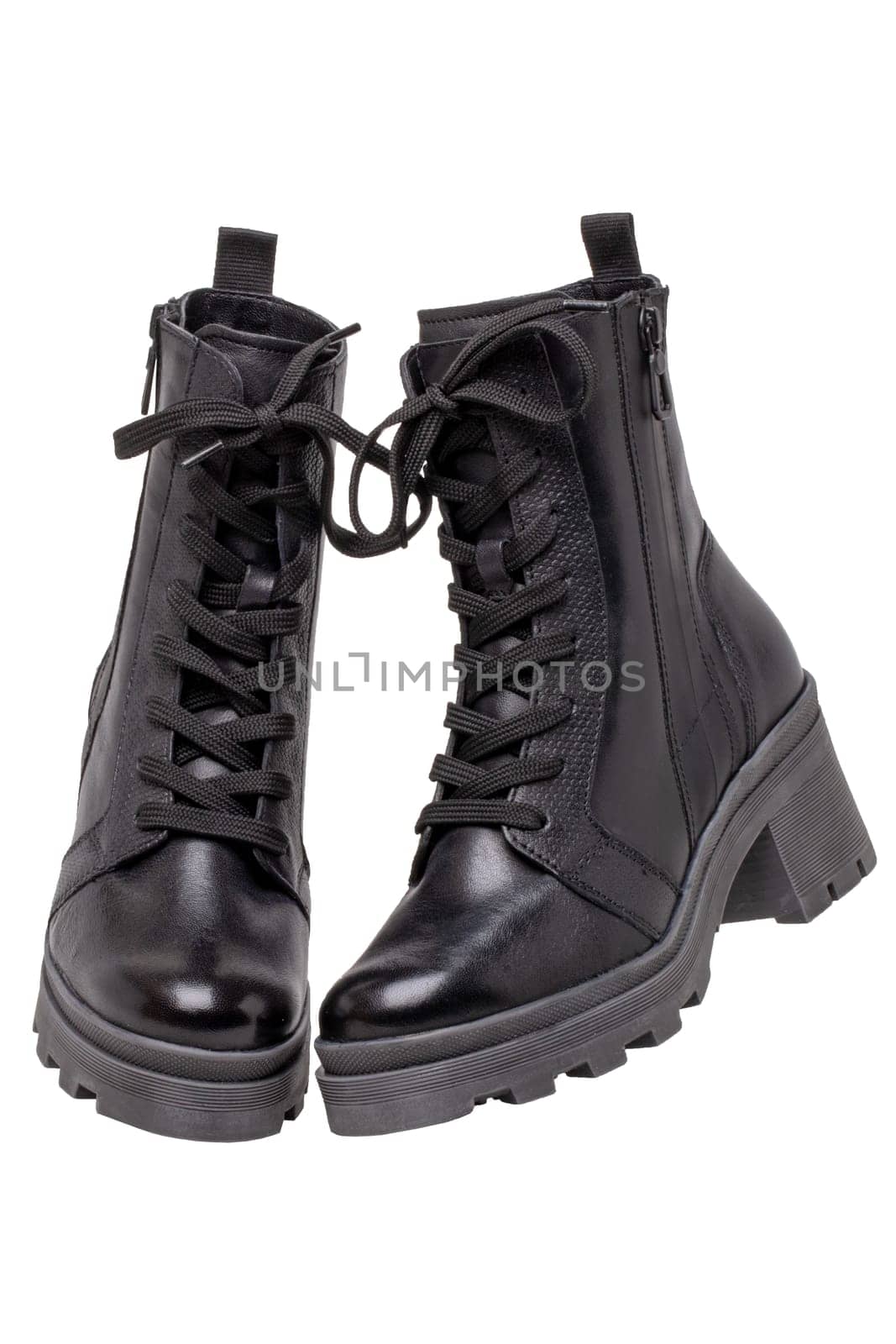 Womens boots. Closeup of female elegant black leather winter boots. Latest trends of winter shoe fashion for girls isolated on white background. Macro.