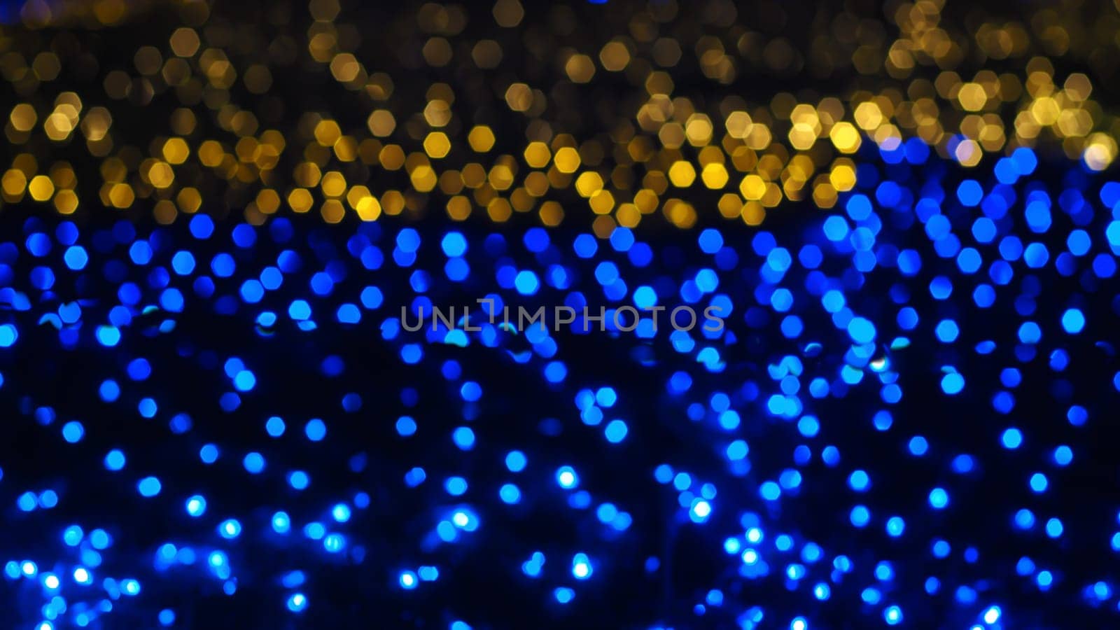 Abstract colorful bokeh light on golden background. Christmas and New Year theme