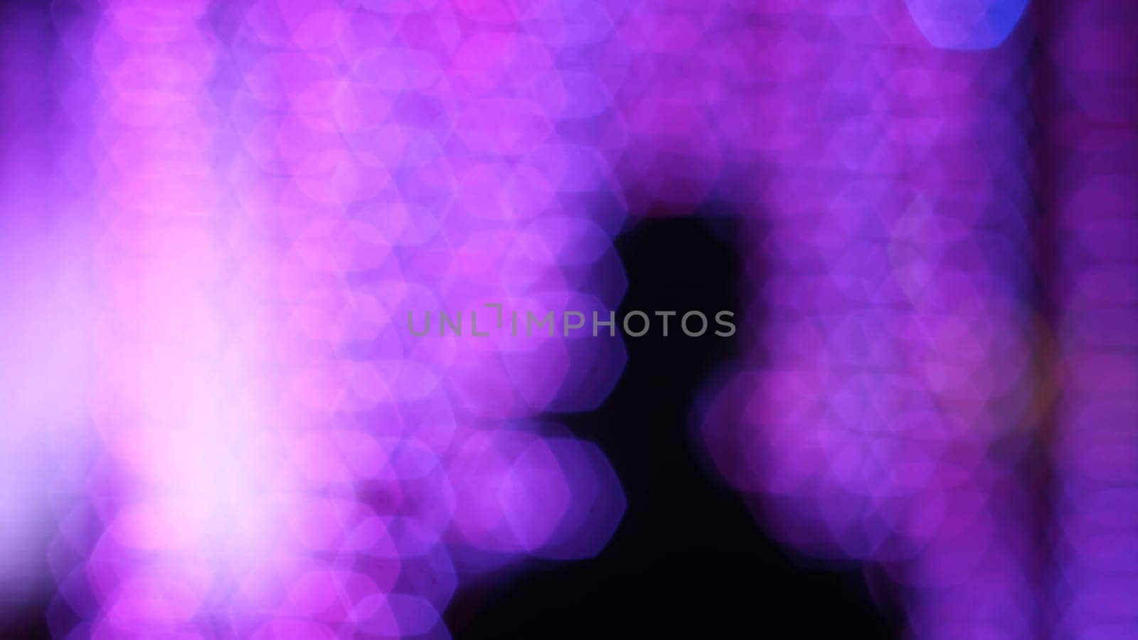 Blurry silhouette man with bokeh, festival lighting  background