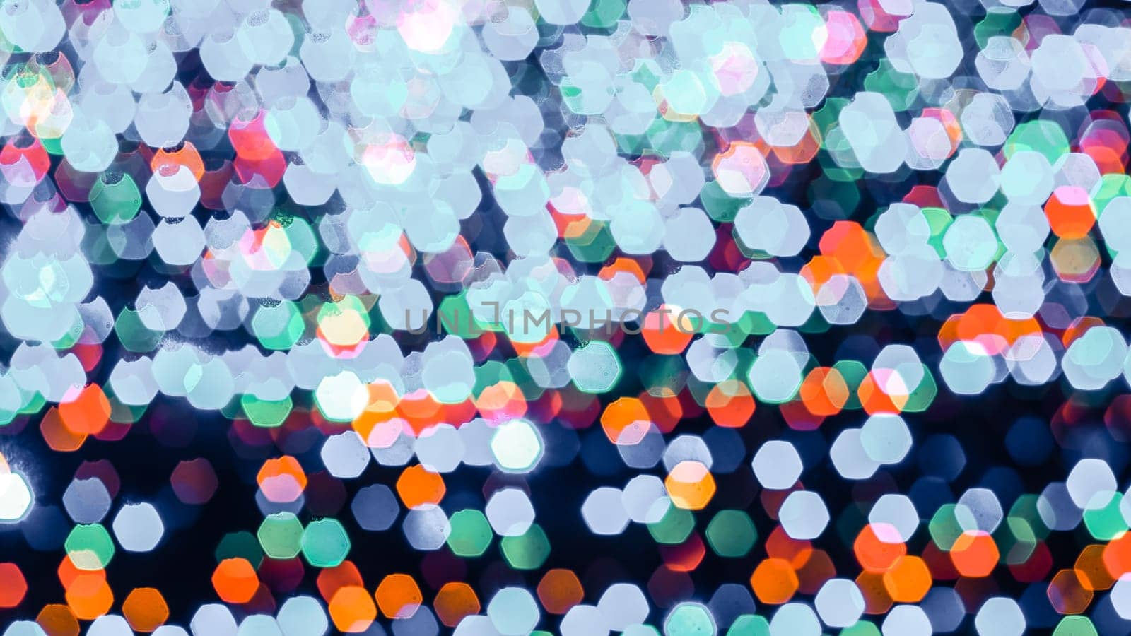 Abstract colorful bokeh light on dark background. Christmas and New Year theme