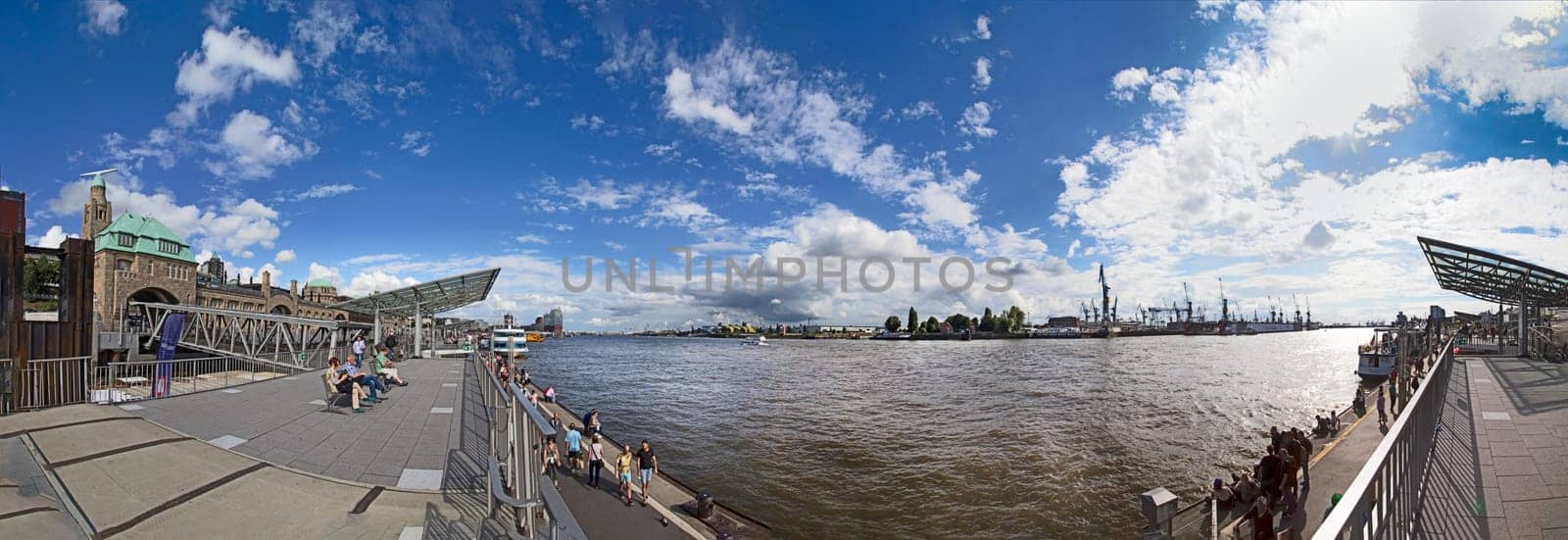 HAMBURG, GERMANY - JULY 30, 2016: people enjoy the view from the Landungsbruecken in Hamburg to the harbor.