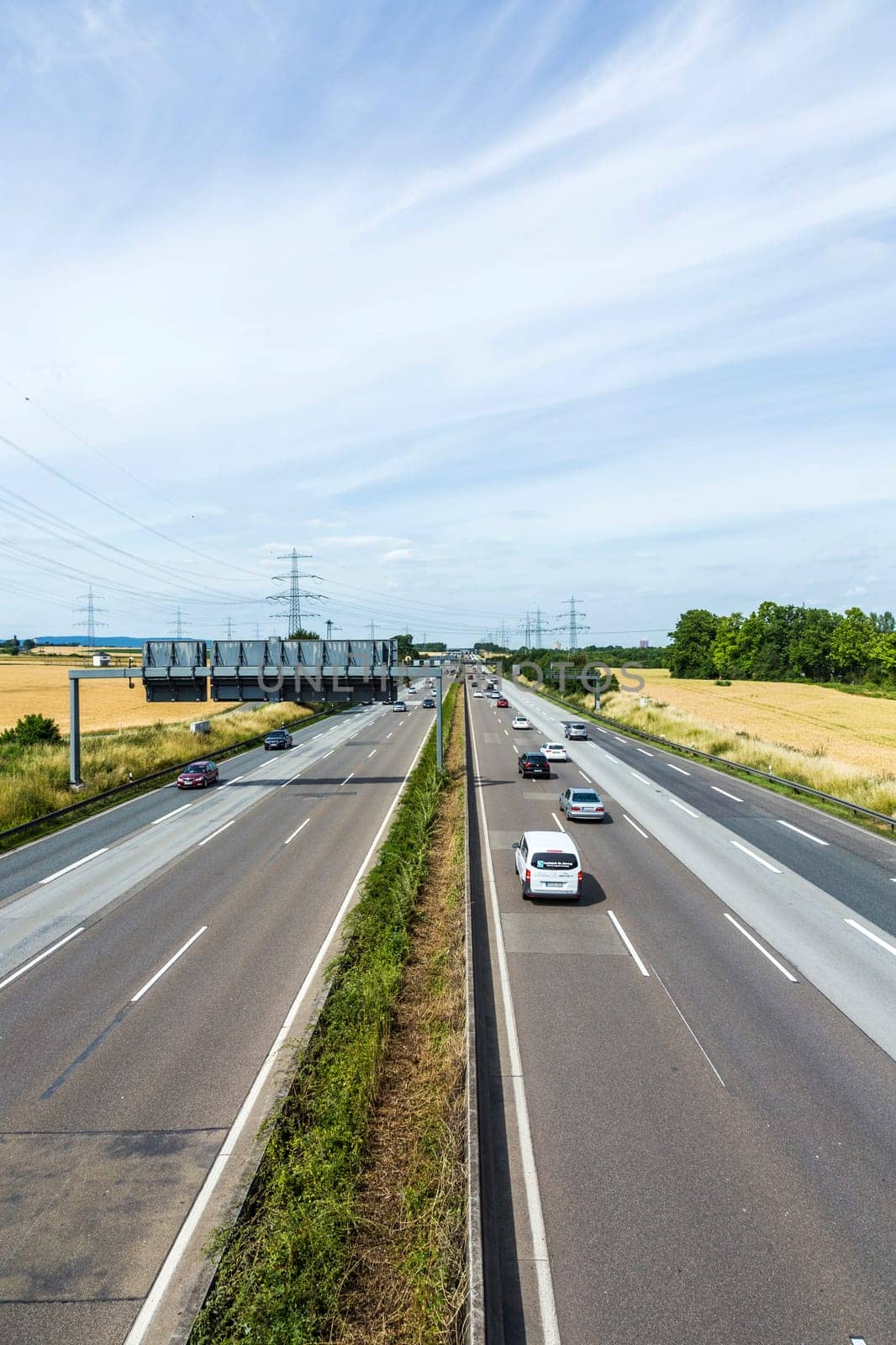 FRANKFURT, GERMANY - JUNE 28, 2015: pattern of highway in Germany with white line markers and car driving on A3