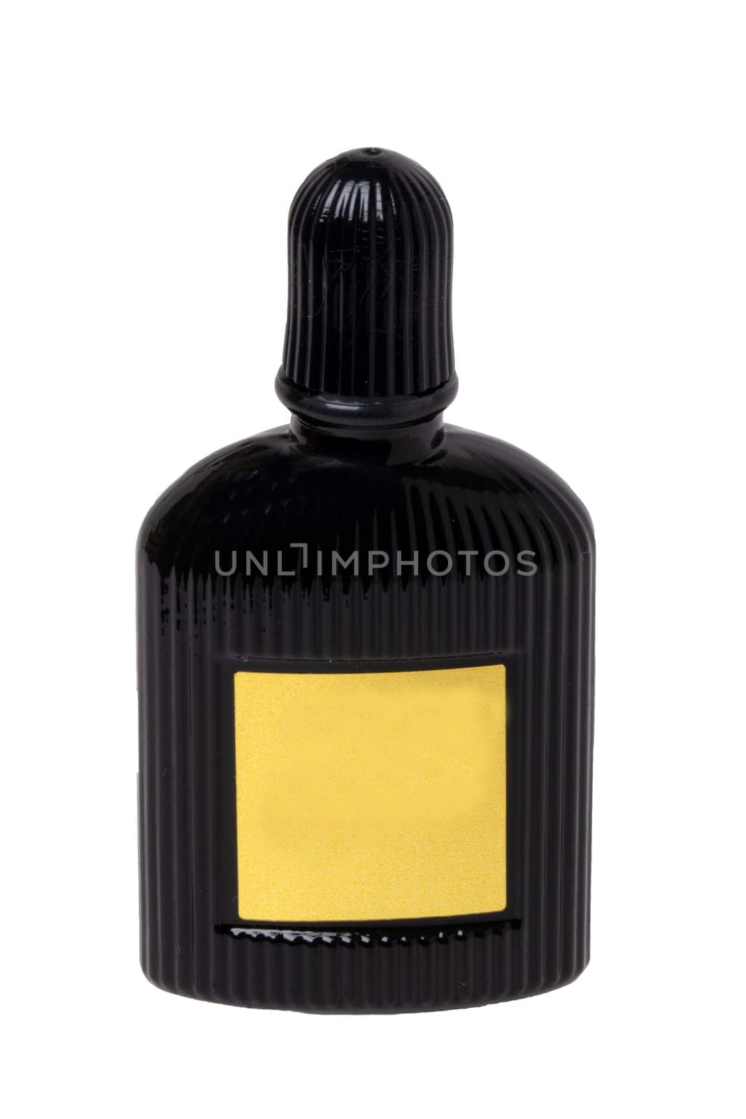 Cosmetic labels. Close-up of a black elegant male parfum glass bottle with empty yellow label isolated on a white background. Copy space. Adbvertising. Macro.