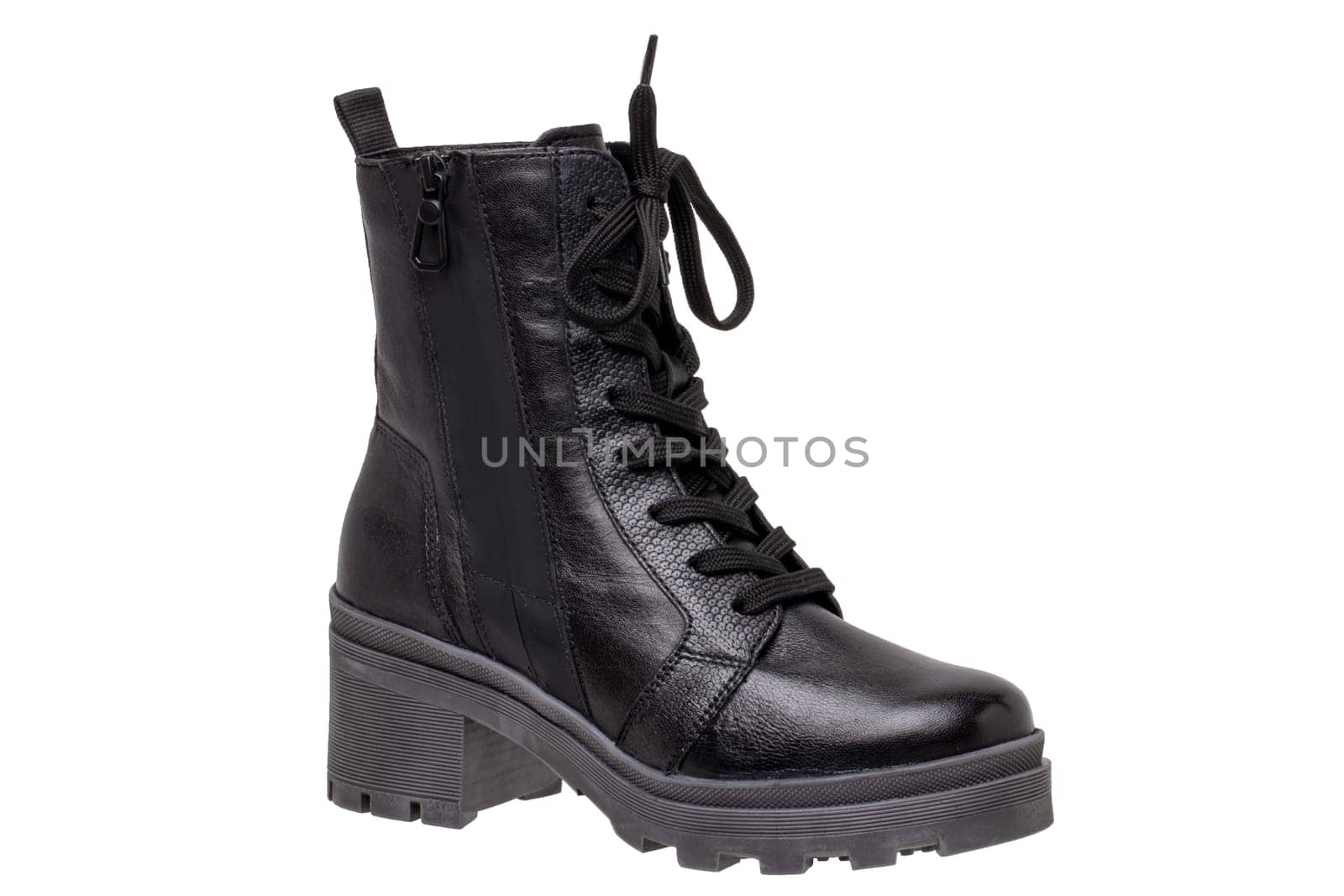 Womens boots and shoes. Closeup of a single elegant black leather winter boots. Latest trends of winter shoe fashion for girls isolated on white background. Macro.
