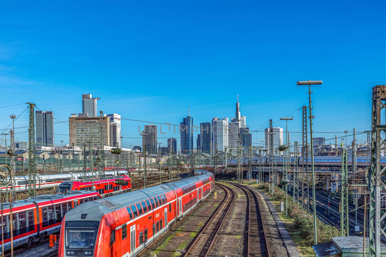 Frankfurt, Germany - Jan 10, 2020: view to central station Frankfurt with rails and Train an skyline of Frankfurt downtown.