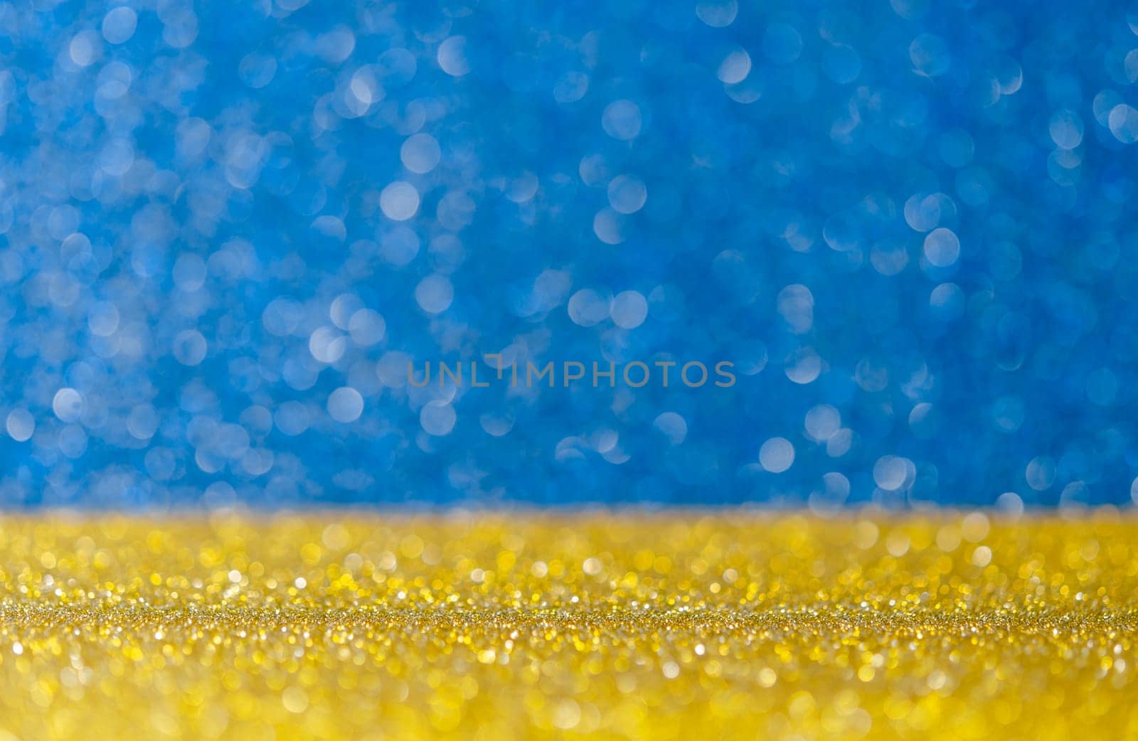 Golden glitter lights with abstract blue bokeh background