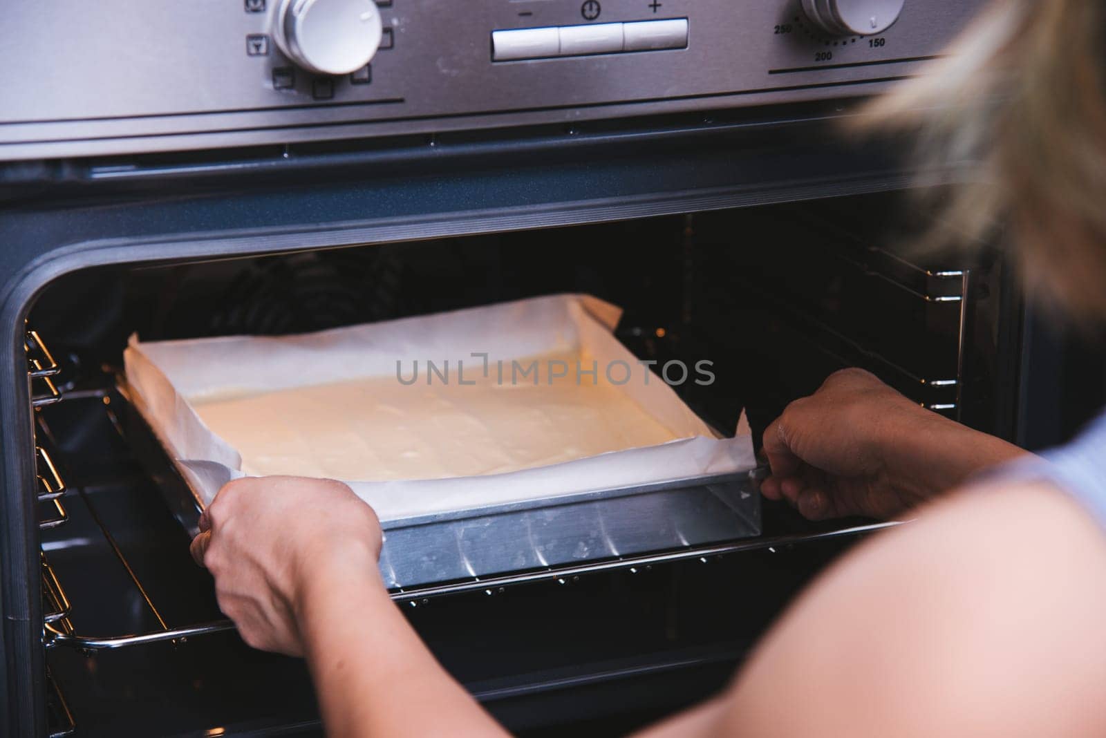 Hands of baker woman holding dough bread bakery cake fresh on front oven