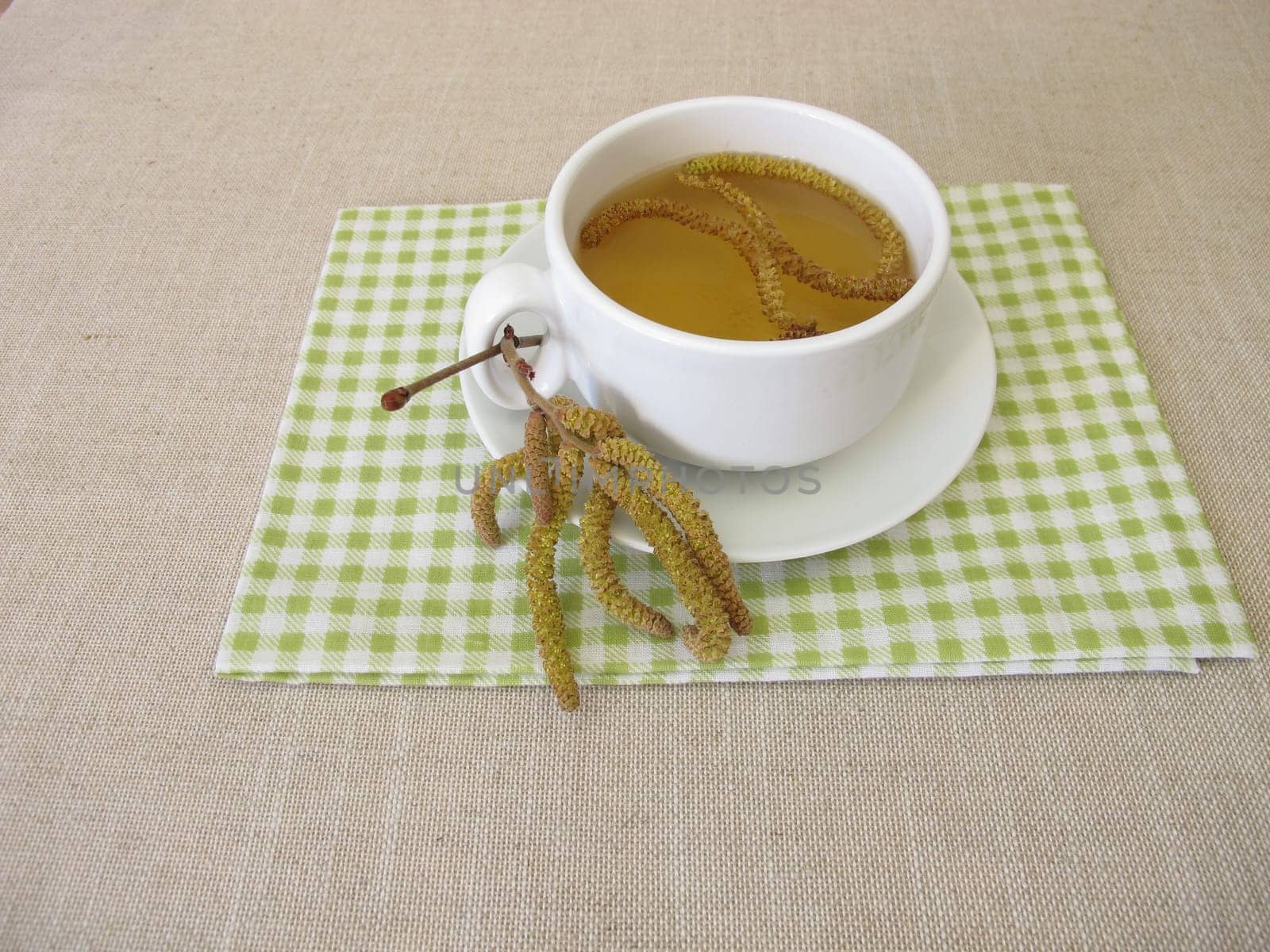 Herbal tea with hazel catkins, hazel flowers from hazel shrub