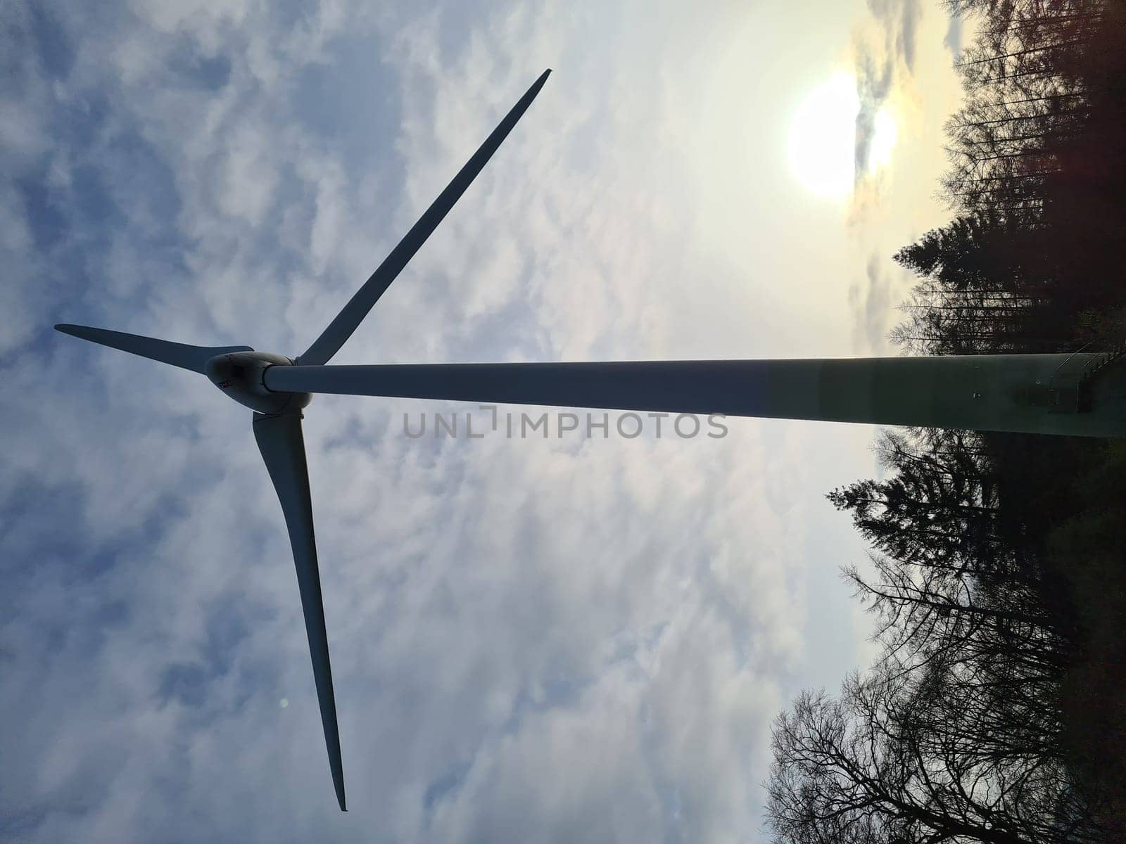 Wind turbine in the evening sun landscape. Alternative energy concept