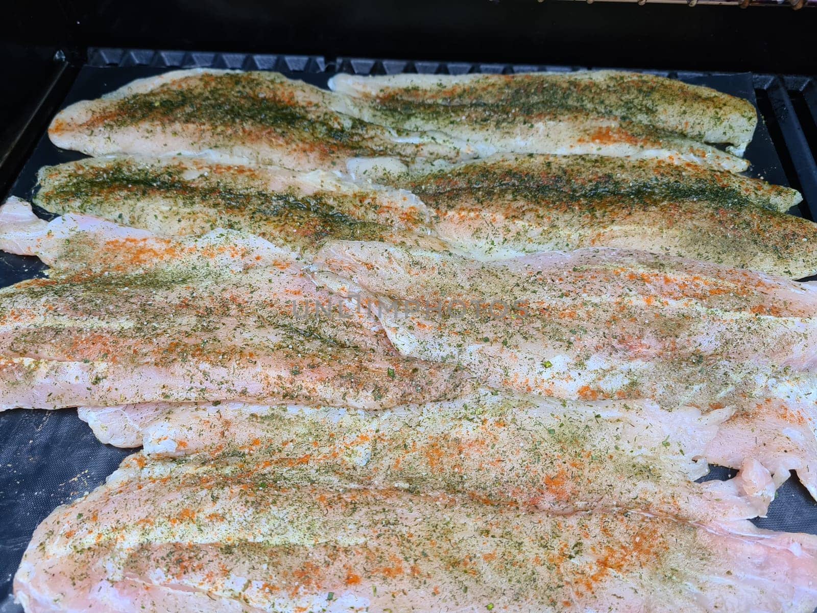Professional chef cooking fish on a barbeque
