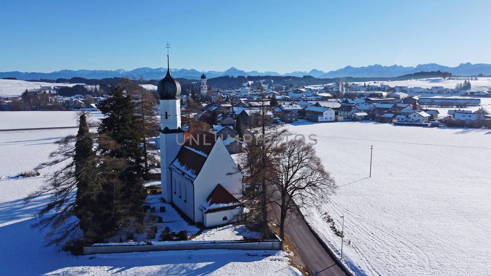 Drone image of the two churches near Leuterschach in Bavaria in front of the Allgaeu Alps in winter