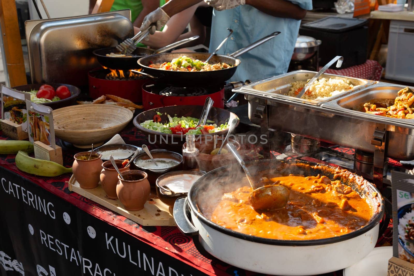 Cheff cooking fusion international cusine on street stall on international street food festival of Odprta kuhna, Open kitchen event, in Ljubljana, Slovenia.