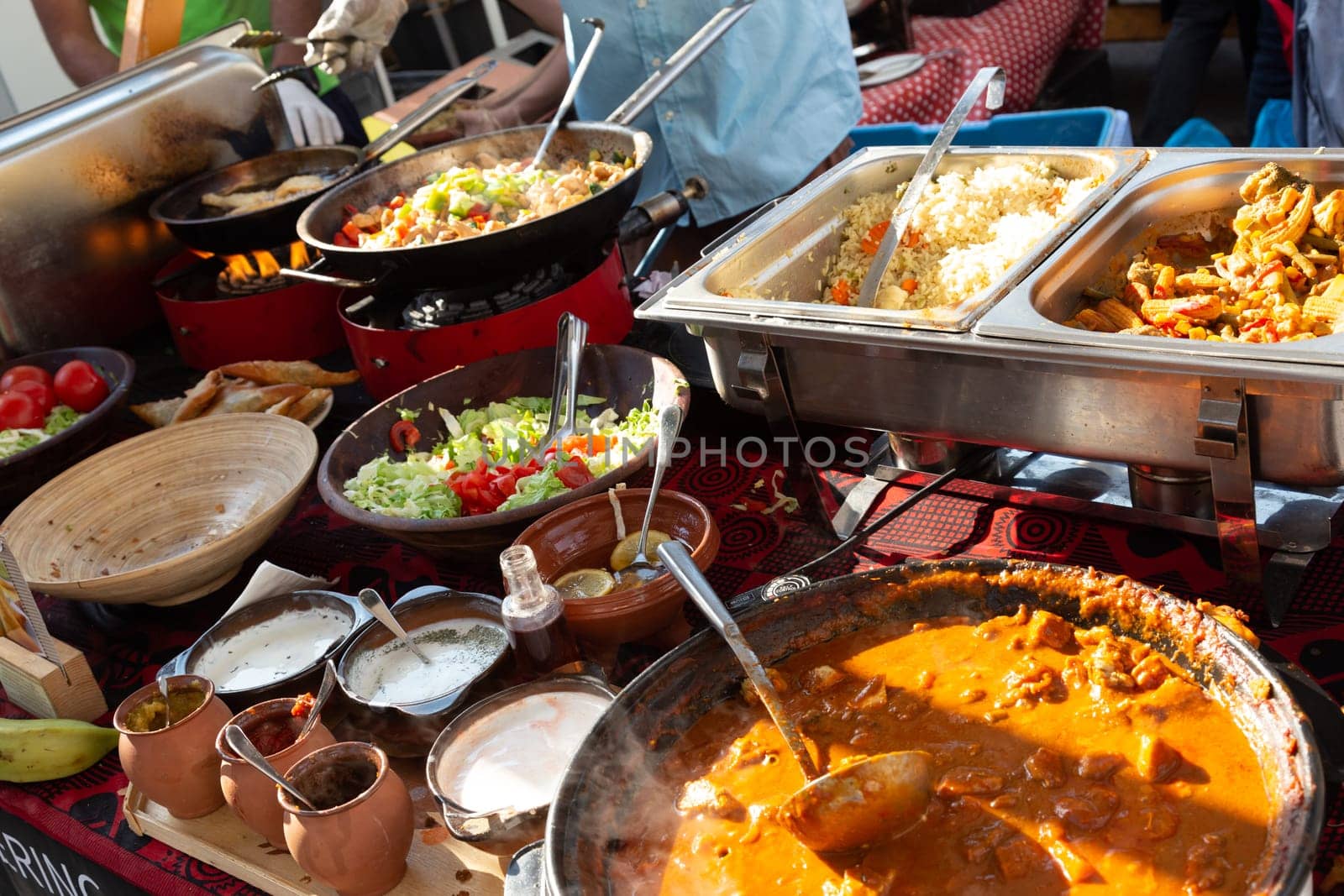 Cheff cooking fusion international cusine on street stall on international street food festival of Odprta kuhna, Open kitchen event, in Ljubljana, Slovenia.