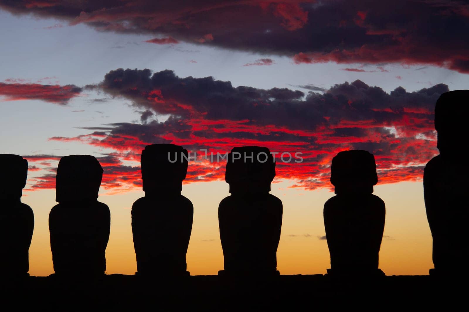 Dramatic colorful sunrise over Moai stone sculptures at Ahu Tongariki, Easter island, Chile