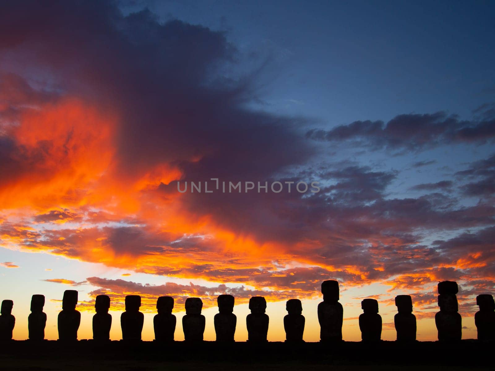 Dramatic colorful sunrise over Moai stone sculptures at Ahu Tongariki, Easter island, Chile