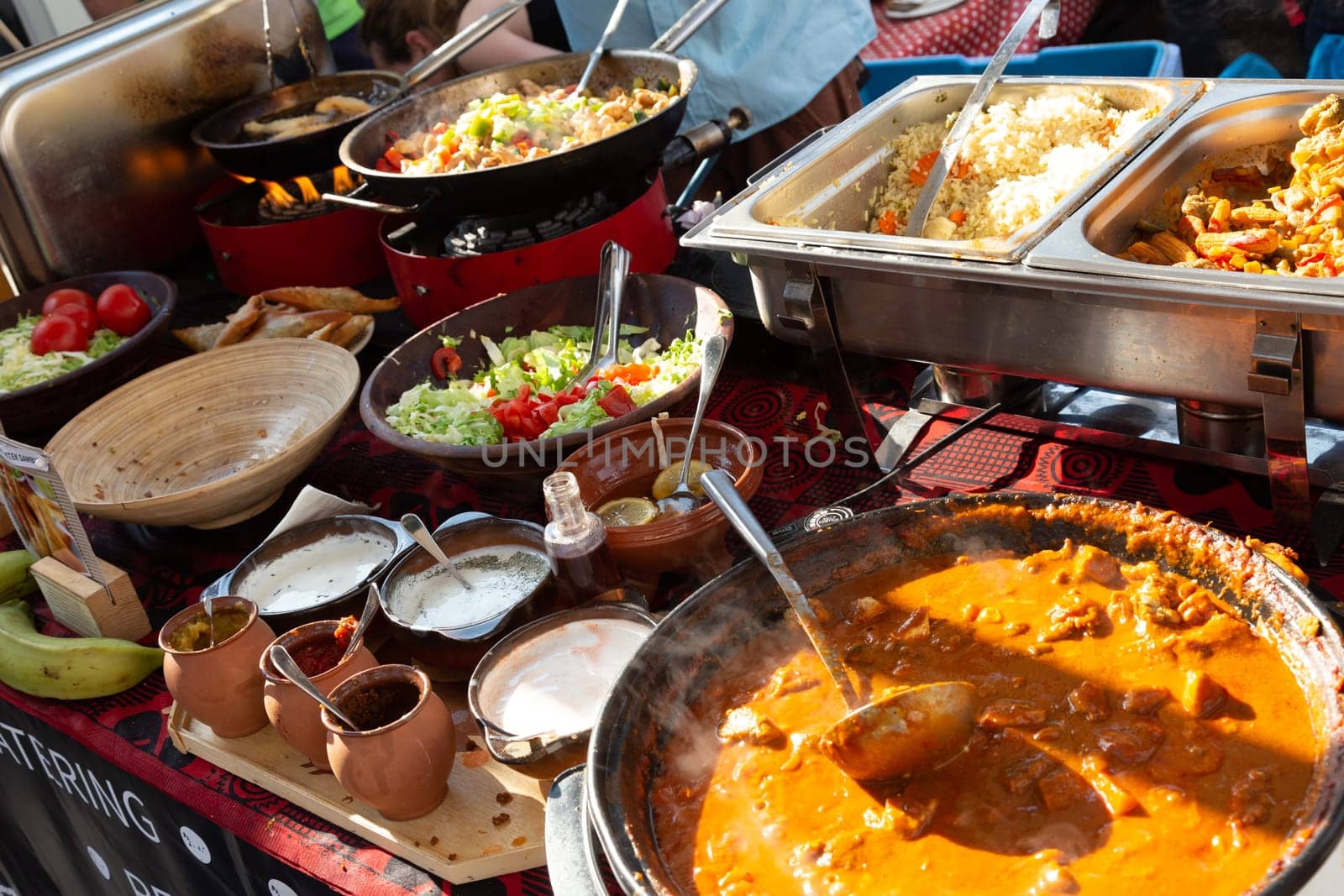 Cheff cooking fusion international cusine on street stall on international street food festival of Odprta kuhna, Open kitchen event, in Ljubljana, Slovenia.
