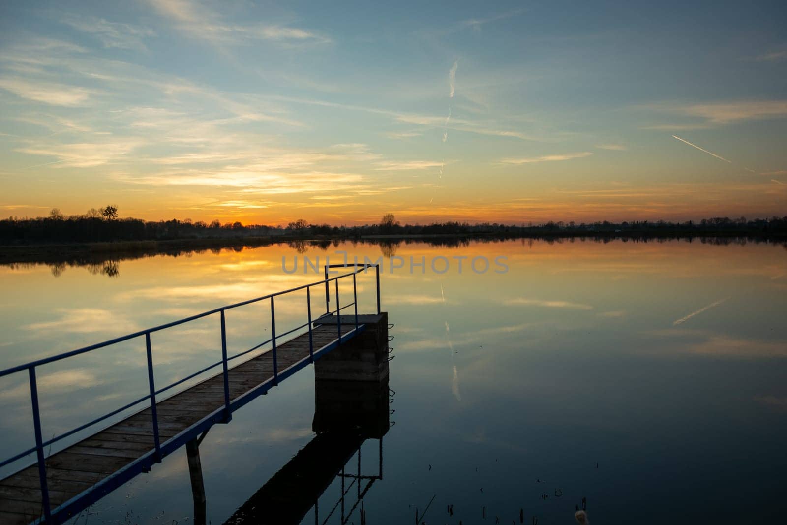 Footbridge on the lake and the view after sunset, Staw, Lubelskie, Poland
