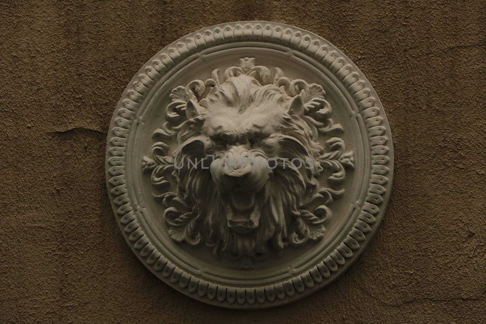 plaster bas-relief Greek characters a lion on a white background.
