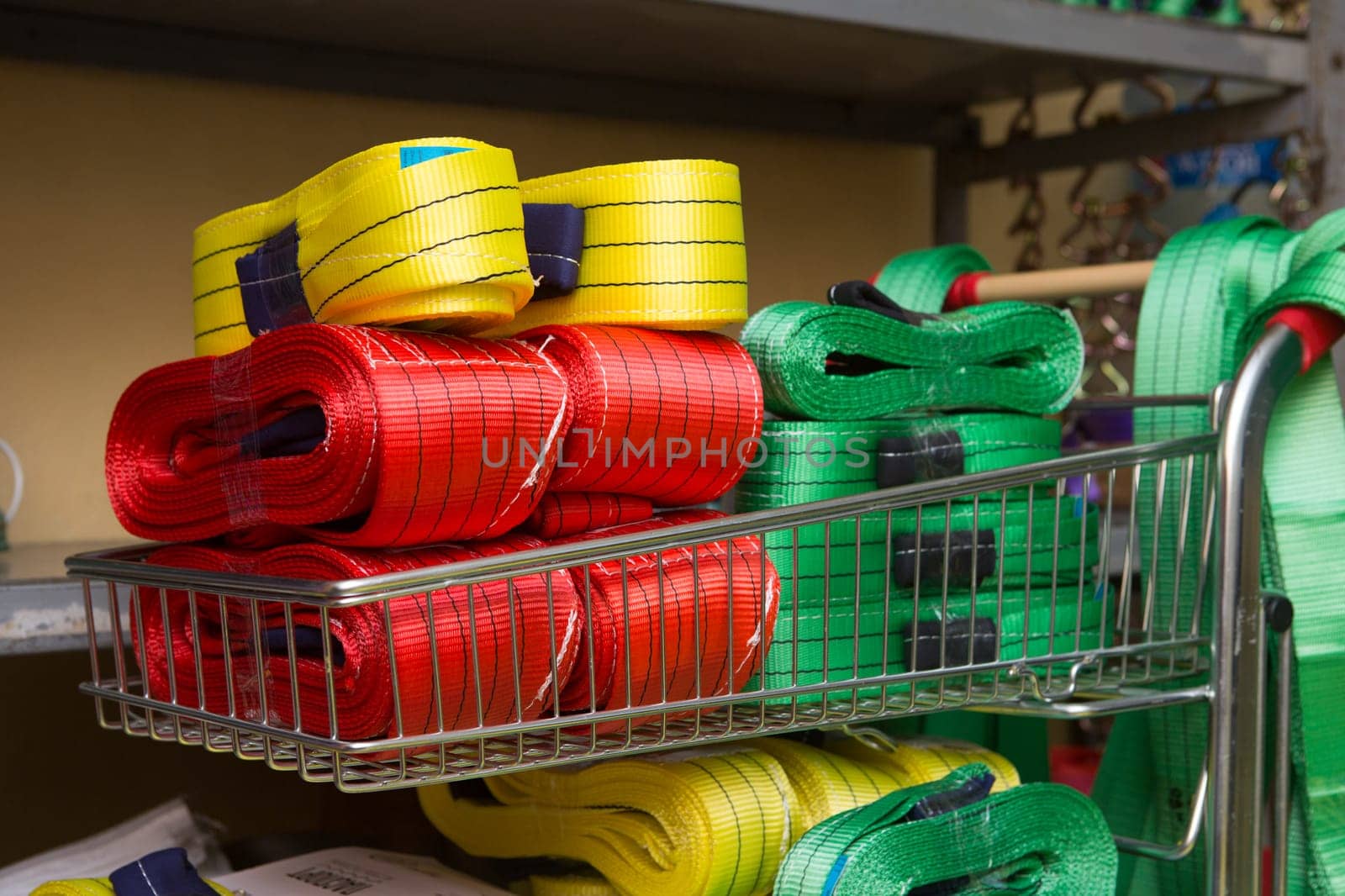 Industrial sewing machine sews a webbing sling. Manufacture of textile slings and tie straps