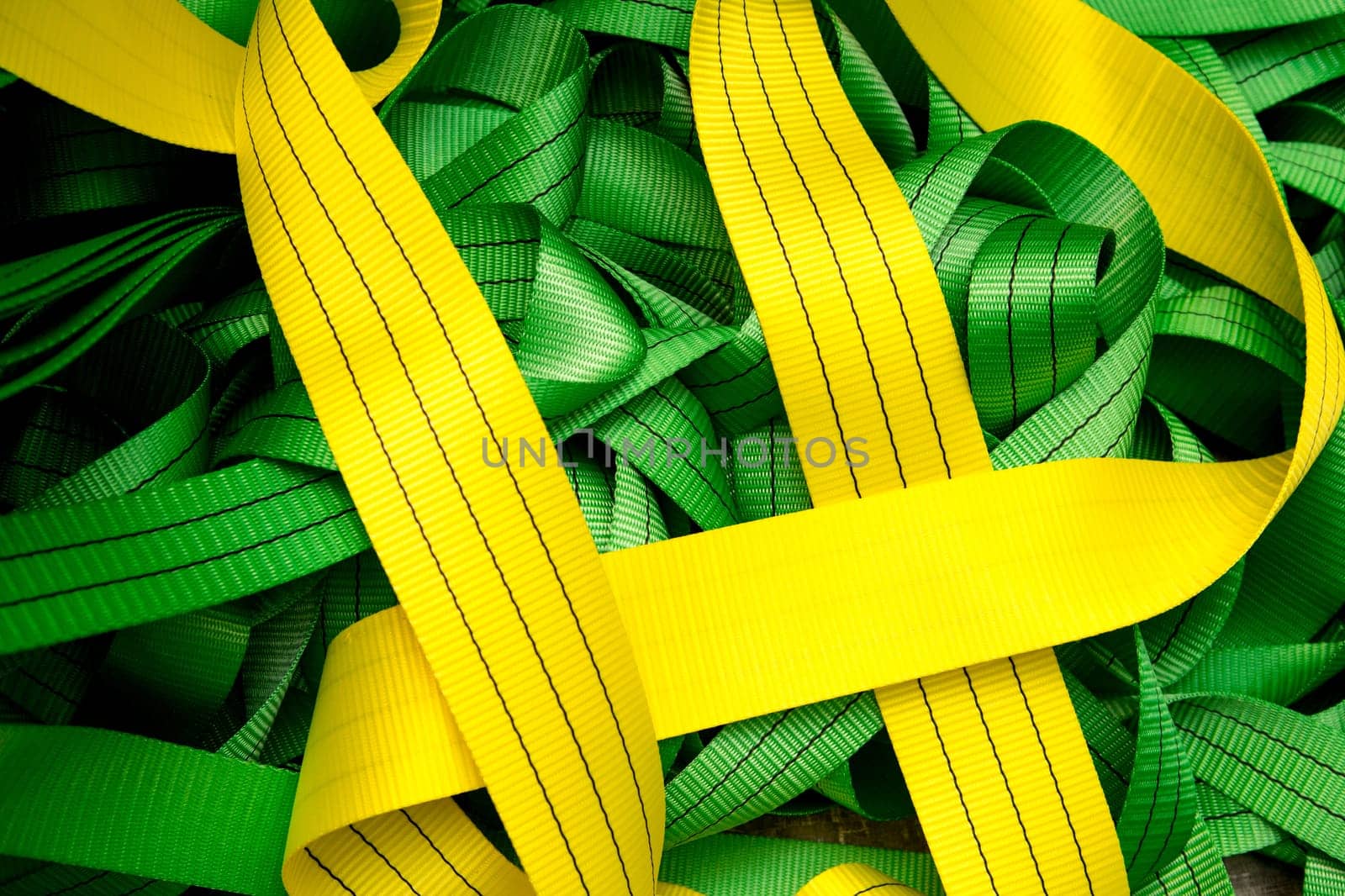 Industrial sewing machine sews a webbing sling. Manufacture of textile slings and tie straps