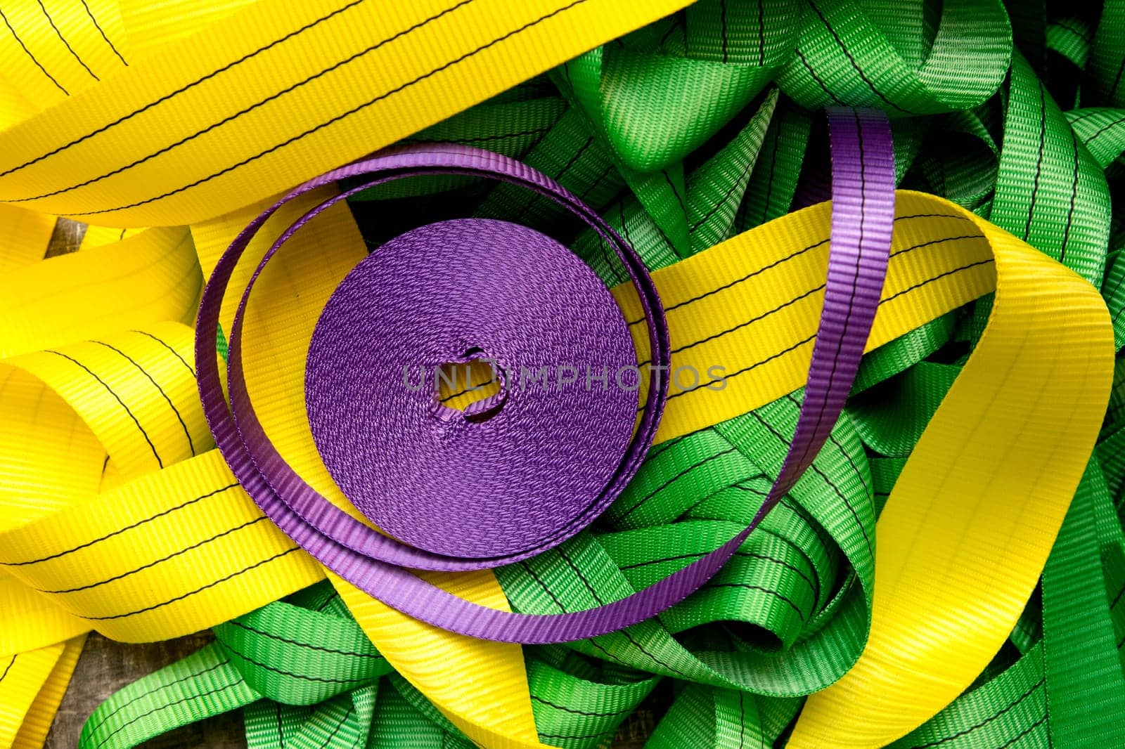 Industrial sewing machine sews a webbing sling. Manufacture of textile slings and tie straps