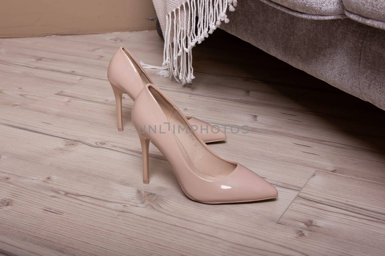 Fashion high heels women shoes beige color. Stiletto shoe style in ladies wardrobe.