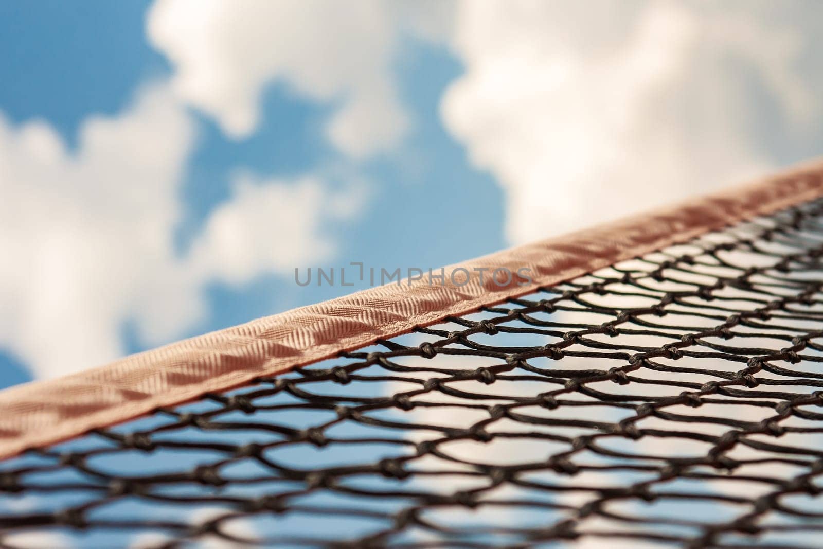 a tennis net against the blue sky