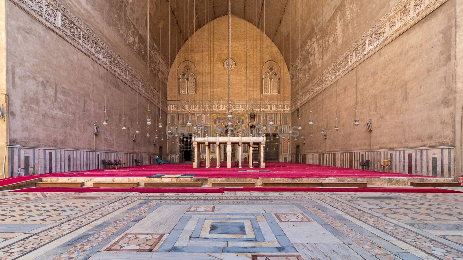 Cairo, Egypt- September 25 2021: Courtyard and monumental main Iwan of Mamluk era historical public Mosque and Madrasa of Sultan Hassan, Old Cairo