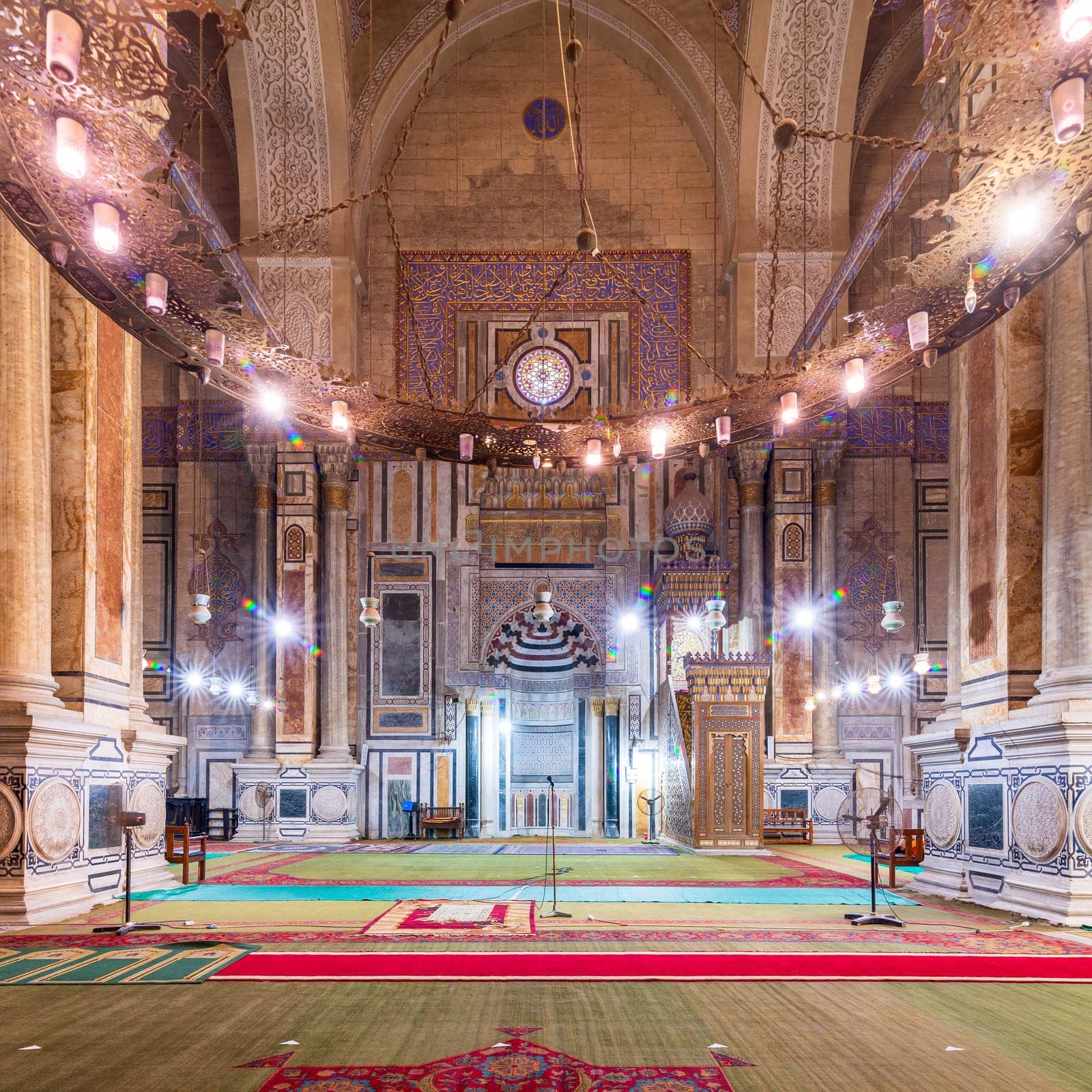 Interior of public historical Al Rifaii Mosque, aka Royal Mosque, with colorful decorated engraved Mihrab and wooden Minbar, Cairo, Egypt