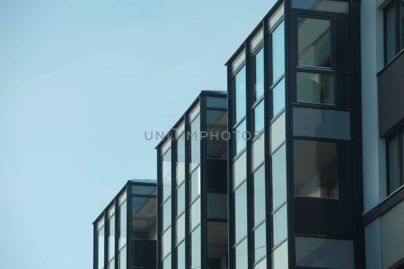 glass building against a blue sky low angle of view, minimalism in architecture